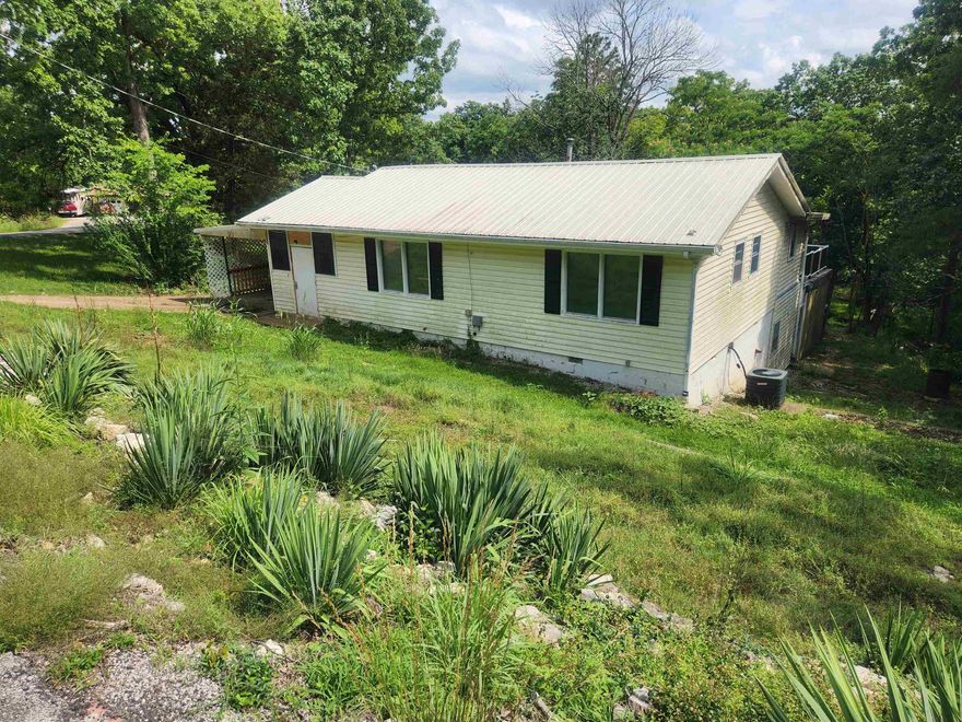 FULLY FURNISHED, Really cute 2, bedroom 2 bath home in the heart of Cherokee Village.  One car carport. Central heat and air, 2 water heaters, one electric and one gas. there is a garage door on the lower level in the back along with a large, covered carport area. Inside the garage is a workshop with some tools. There is a Solar System on site just waiting to have the installation completed. Batteries, inverter and solar panels on site. There is a fenced in garden area in the back and the makings of a rainwater catchment system is started. This is a great opportunity for a fully move-in ready home, all furnishings, appliances, dishes stay. It can use a little clean up but for this price it is an incredible opportunity as a starter home. To be sold As-Is. Make an appointment today to see this place.