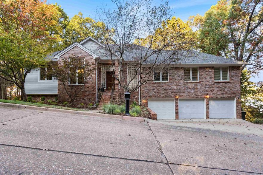 Fabulous home nestled on 1.35 acres within the private, gated community of River Ridge Pointe with breathtaking views of the Arkansas River. This home combines timeless architecture, a soft contemporary design style and has been thoughtfully renovated creating many features and amenities for the perfect living experience. Upon entering the home, you are drawn to the two-story great room with cozy fireplace and wonderful natural light from large windows. The great room flows seamlessly to the dining room, renovated gourmet kitchen with Thermador appliances and an outdoor deck with sleek linear railing and sustainable decking material. The primary bedroom suite is on the main level with a spa-like bathroom that was beautifully renovated. A den is located on the main level with fireplace, bookcases and pool table. The lower level also offers incredible views of the Arkansas River and features three bedrooms and a hall bathroom, laundry room and third living space with fireplace.  Additional noteworthy features include: a three-car garage, plantation shutters and motorized window coverings, new roof (2024), hardwood floors throughout (no carpet), pre-inspection with repair receipts.