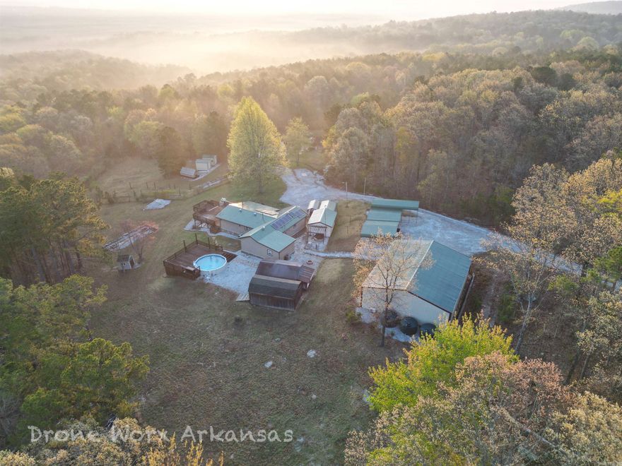 A 43+/- acre parcel divided into two.  This one with 22 acres+/- and the neighboring parcel with 20 acres +/- or both, together for additional cost and space.   This property a 2 bed, 2 bath home in excellent condition with so many extras you will have to read the full disclosure in the AGENT REMARKS.  The open concept home is a show stopper with the granite counter tops, large island, wet bars, large decks with a pool, seating, and brick oven.  And for the perfect homestead property, included is a 40X50 shop and several smaller buildings for storage, offices, or whatever you can think of.  With the green house, chicken coop, sheds, carports, water collection materials and pond, it's a great setup for rural, independent living.  A more peaceful life can be found here with the solar, propane generator, storm shelter and located just outside of Clinton where there is a hospital, shopping, and food. It's the right choice for settling down for a better life.  The adjacent parcel (also for sale, 653 Blair Rd) has a 14X32 furnished cabin for friends and family to come visit and RV carport with power hook up.   For more details, check out the AGENT REMARKS.