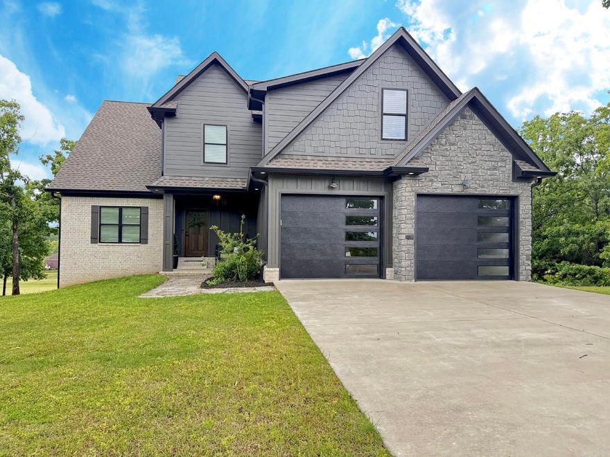 Welcome to a custom built showstopper in Greystone perfectly positioned on the golf course near Cypress Creek Golf Club. Built in 2022 this home offers over 3000 square feet of thoughtfully designed living space with 3 bedrooms plus a media room that can easily function as a 4th bedroom along with 3.5 baths. From the moment you walk in the open layout and expansive windows draw your eye straight to the 10th fairway creating a seamless indoor outdoor feel. The kitchen is a true centerpiece with a massive island quartz countertops and a custom walk in pantry designed for both everyday living and entertaining. Wood beams and ceilings add warmth while the fireplace creates a cozy focal point. Step outside to your outdoor kitchen and fireplace perfect for hosting or unwinding after a day on the course. Additional features include a golf cart garage with extra storage and a striking black and stone exterior that sets this home apart.