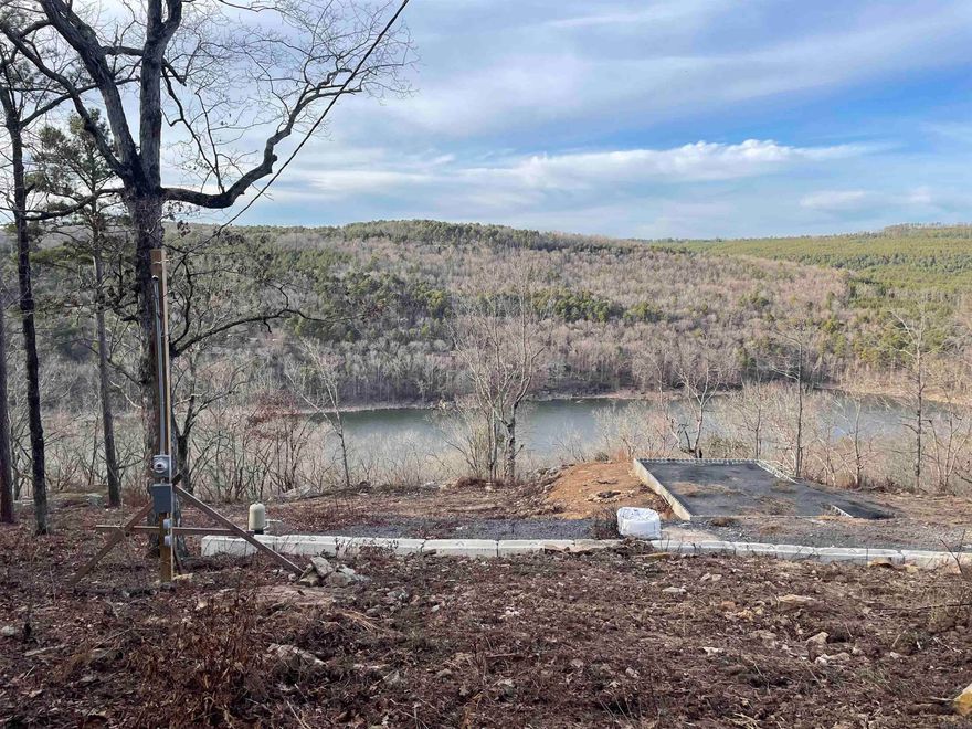 Ever dreamed of a cabin with a lake view? This beautiful 1 acre M/L lake view lot sets back at the end of a quiet little subdivision. With a 24x18 foundation ready for your tiny house or cabin. With the foundation, water well and perc test from 2023 this lot is ready to be YOUR HAPPY PLACE. Seller is willing to remove pad if needed.