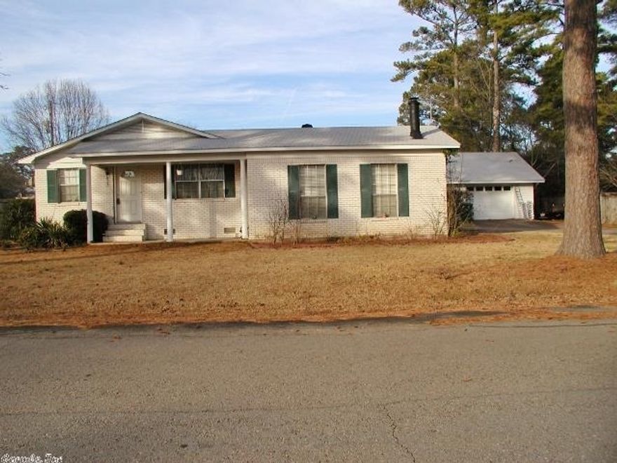 Move in ready property with plenty of space.  Separate living room and large sunken family room with fireplace.  Quaint eat in kitchen. Fenced yard along with 2-car detached garage/shop and ideally located in walking distance to public school and college.  New roof and outside air unit 2012.