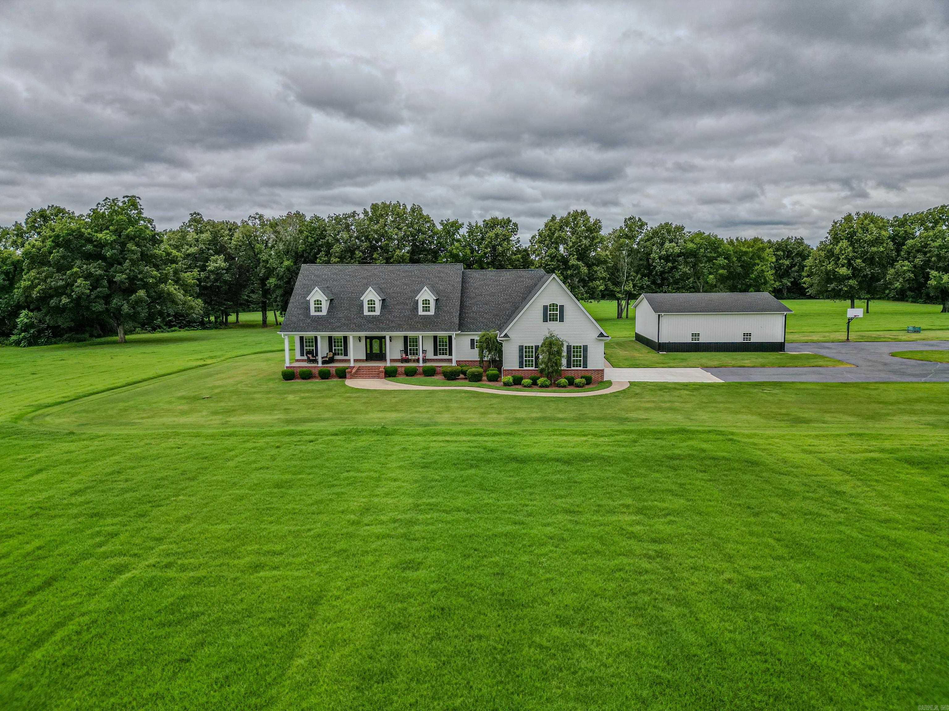 Stunning estate on over 46 acres of land, Paved Road and Tree lined paved driveway w/ all underground utilities lead to a large shop and immaculate 2 story home with over 4600 sf 4br, 3.5 bath total, the main floor offers an expansive screened back porch, three large bedrooms, an office and 2.5 baths, large laundry w/built-ins for storage and an Island Kitchen with Corian countertops including stainless built in appliances. Make your way upstairs to enjoy an exercise area/game room and additional living space or theatre room option with a full bath and bedroom.Additionally an over sized two car garage, storm shelter and abundance of storage, This farm is not just a residence it's a retreat, offering a blend of agriculture and upscale living, an ideal setting for those who treasure tranquility and comforts of a well designed home and land layout. Whether you are searching for a peaceful haven or passionate about other options for this land and home, offering a harmonious blend of convenience and country living this property is a must see. Home warranty provided