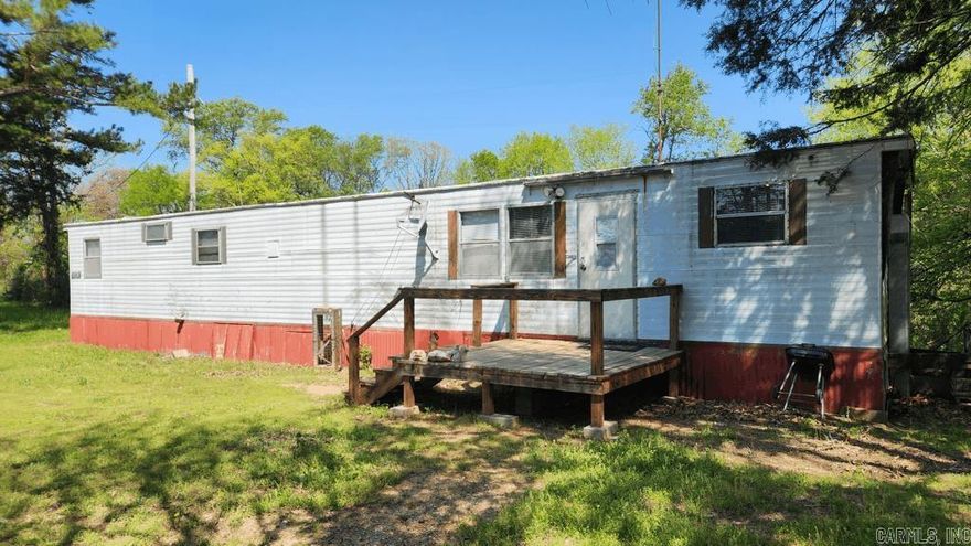 Hunting/Fishing camp on Highway 298 at Story. This 0.43 acre tract is fully fenced and has a survey. 1967 2 bedroom 1 bath, mostly furnished. There is a well with good water and submersible pump, 2 rv plugs, a well house, and 4 storage buildings. No restrictions. Mineral rights convey. About a mile to Ouachita National Forest, and about 2 miles to Lake Ouachita.
