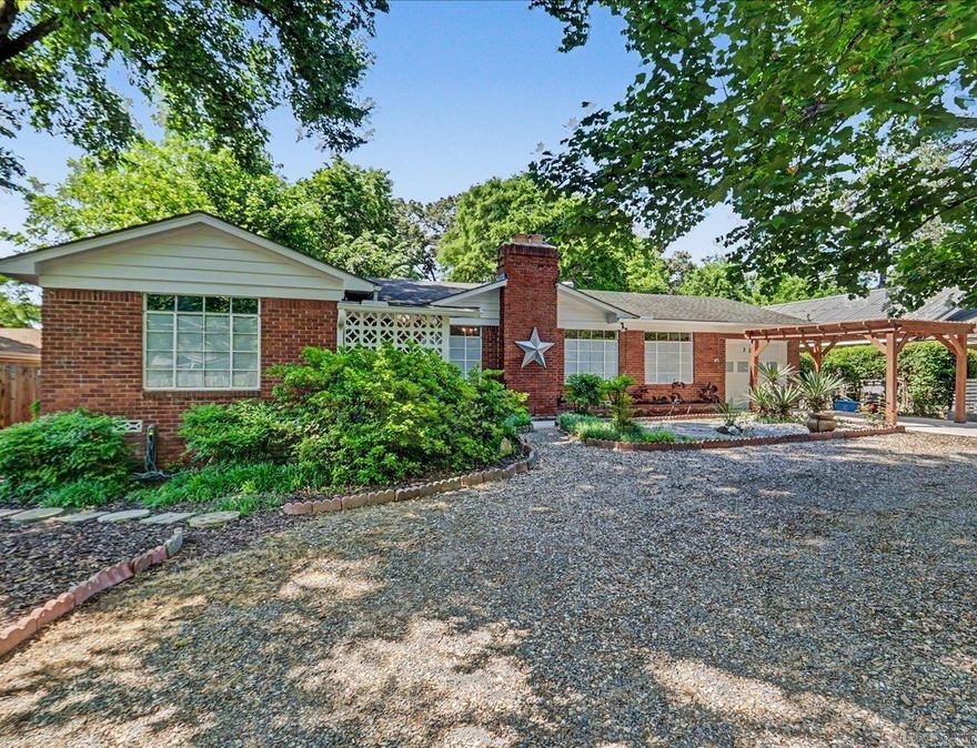 Prime location near Oaklawn Racing Casino Resort—this 3-bedroom, 1.5-bath home offers a blend of classic charm and thoughtful updates.  Interior features include beautiful hardwood floors throughout, a natural gas fireplace, and a gas stove. The kitchen provides abundant storage and features a Frigidaire Professional high-performance convection oven with built-in Air Bake. Unique touches include original Czechoslovakian chandeliers in the living and dining areas.  Step outside to an updated patio surrounded by crushed granite, creating a low-maintenance outdoor space. The backyard includes an 8-foot gate with alley access, along with an additional front gate for added convenience.  Recent updates include HVAC (2021), water heater (2022), new garage door (2022), a pergola-style carport leading into the garage, and a whole-house surge protector.  The property is enhanced by mature trees, including a distinctive tulip elm and two pecan trees, providing shade and added character.  A unique opportunity to enjoy timeless character, modern updates, and a prime location in one property.
