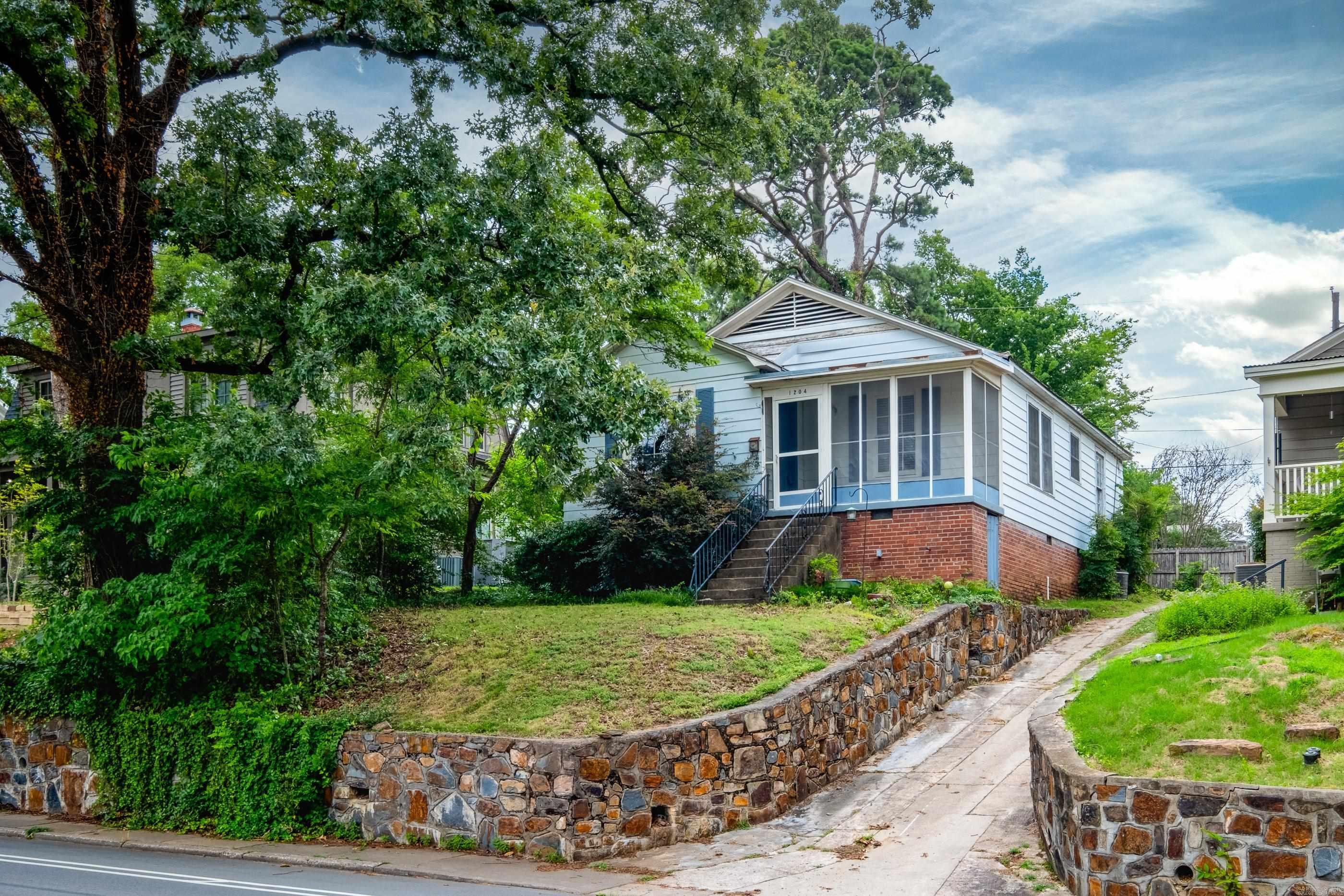 Welcome to cottage living in this perfectly situated home on the iconic Kavanaugh Boulevard in Historic Hillcrest. This charming residence offers an incredible opportunity to own a piece of this vibrant community for under $200,000. A stone walkway leads to a screened front porch to welcome you home and is the perfect spot to sit and relax a while. The kitchen has ample space and features a gas stove for culinary adventures. The spacious open dining room provides a great layout for entertaining. The 2 bedrooms are separated by a hall and bathroom. The backyard is fenced and has a storage building for outdoor storage.