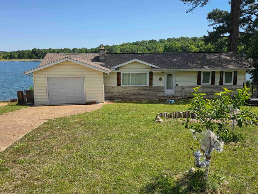 Lakefront home with outstanding views. This 3-bed, 2-bath home on Lake Sequoyah comes with a partially covered back deck that overlooks Lake Sequoyah. 2 beds and 1 bath are on one end of the house, and 1 bed and bath are at the other end of the home. This home is located near the dam so deep-water access is right out your back door. It has nearly a full-length sunroom with its own ductless HVAC system. It has a boat dock along with over 125' of lakefront shoreline. Prime location for fishing and swimming. There is a shop/ basement/ storage area. New Architectural Shingle roof in 2022. New septic system in 2023.   Nice sized one-car garage with remote door opener. All electric aside from the beautiful gas-log fireplace and an on-demand water heater. Located in a cul-de-sac so there is minimal road noise or traffic. Brand new hardwood floors just installed. Most furniture and appliances stay making this a truly move in ready home. Make an appointment to come see this beauty and start planning your afternoons on the lake and evenings on the back deck.
