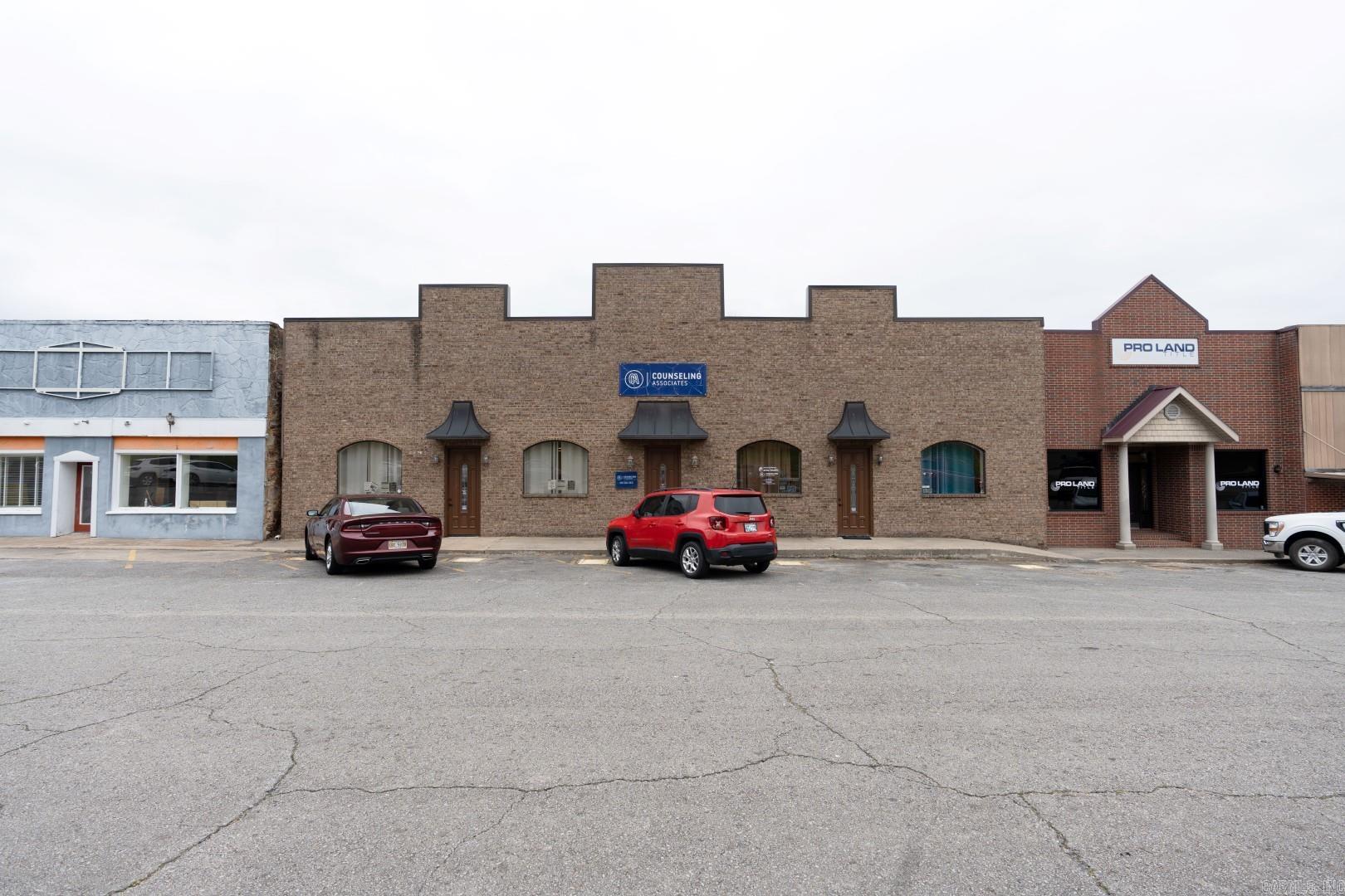 Large commercial building on the courthouse square in Heber Springs! 2 of the 4 areas in the building are rented. The two rented areas leased for $700.00 and $650.00 each per month, and are one-year contracts that will expire in about January of 2026. Tile floors, tall ceilings, 6 restrooms, storage areas, several private office, large meeting rooms, reception area, private parking in the rear of the building and lots of community parking around the courthouse! A long hallway goes thru the middle of the building...the layout can accommodate 1 tenant or up to 4 different tenants! Seller installed a new roof (about $50,000) in the Summer of 2018.