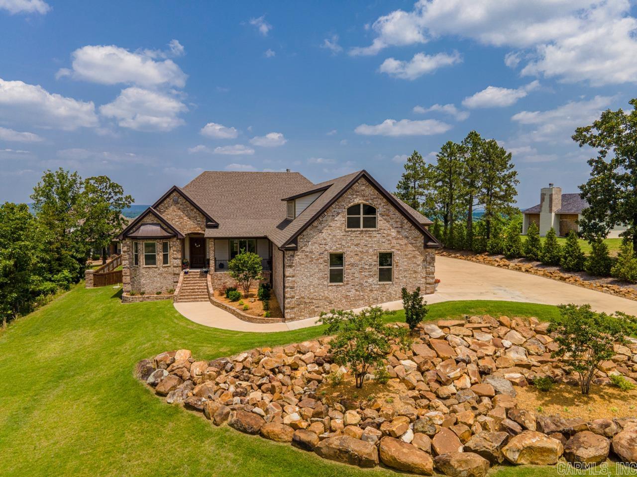 Gorgeous natural brick home with mountain, river, & valley views in the gated Mountain Crest Estates. You are going to love living here! Walk in to an open living room to large dining area with views of Pinnacle Mountain & the Arkansas River. The kitchen has stainless steel appliances & lots of countertop & cabinets space with a huge pantry. It's open to the living & hearth rooms (or large breakfast nook) with a fireplace and just off of the screened in porch. The master bedroom has plenty of room for a sitting area and the ensuite has a soaking tub, separate shower, dual vanities, & large walk in closets the lead to the laundry area. On the other side of the home are two more bedrooms (one with a bay window view of the mountain & river) and a full bathroom. Upstairs are two large bonus spaces that you can use for a 4th & 5th bedroom or an office & game room, media room, play room or whatever you need. There is also another full bathroom and a walk out balcony/porch overlooking the river and the valley & a "hallway" large enough for a small fitness area. Don't forget the indoor/outdoor kitchen that is being used as a cigar room! Don't wait to see this amazing home!