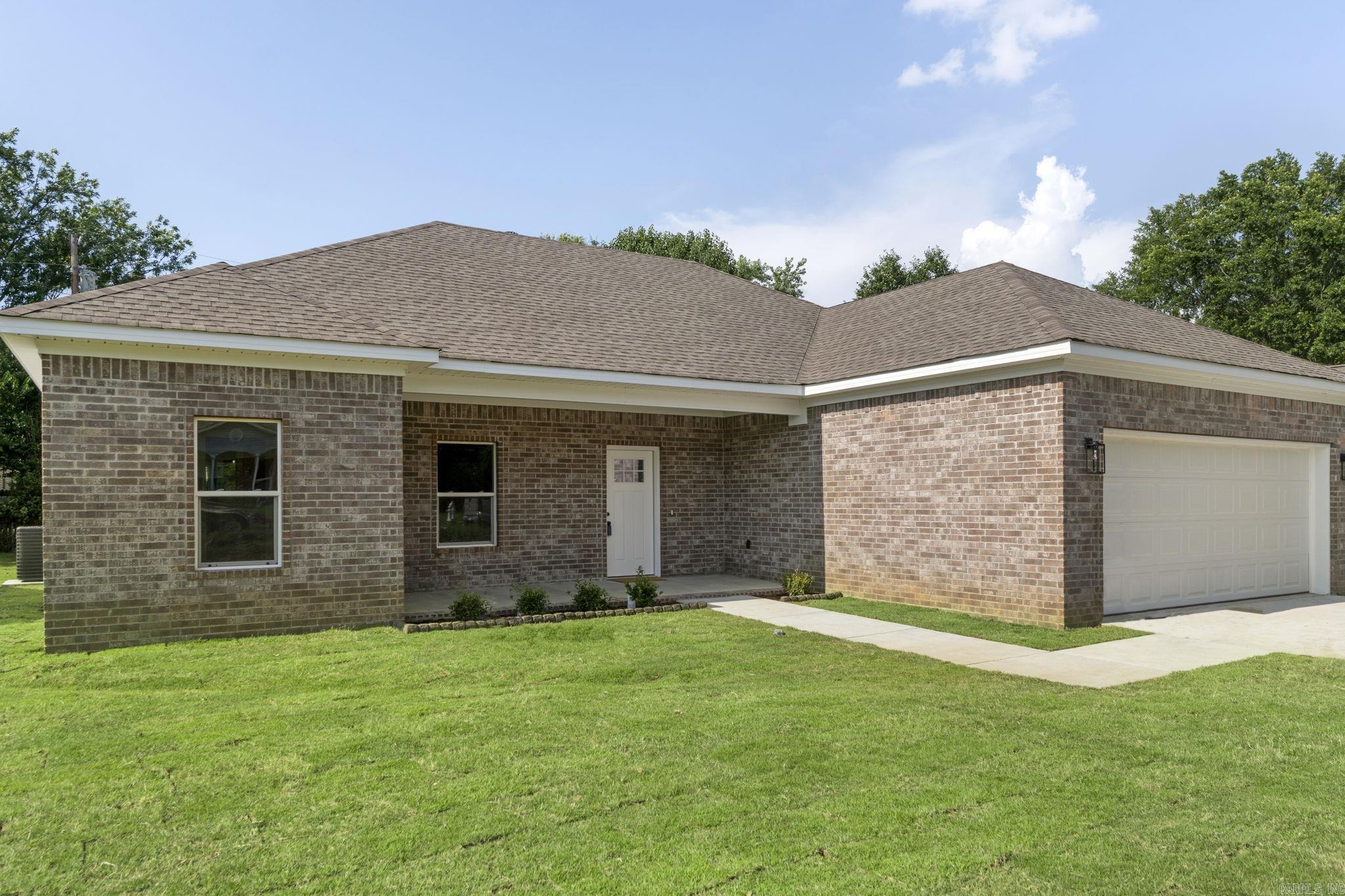 Affordable new custom home in a quiet neighborhood! This 3-bedroom, 2-bathroom house features an open living/dining floor plan with luxury vinyl plank floors and 9' ceilings. The kitchen includes a granite breakfast bar, deep sink, and modern appliances. The master bedroom boasts a 10' pan ceiling, and the master bath offers a separate shower, tub, and walk-in closet. A large laundry room adjoins the oversized two-car garage. One-year builder's warranty included.