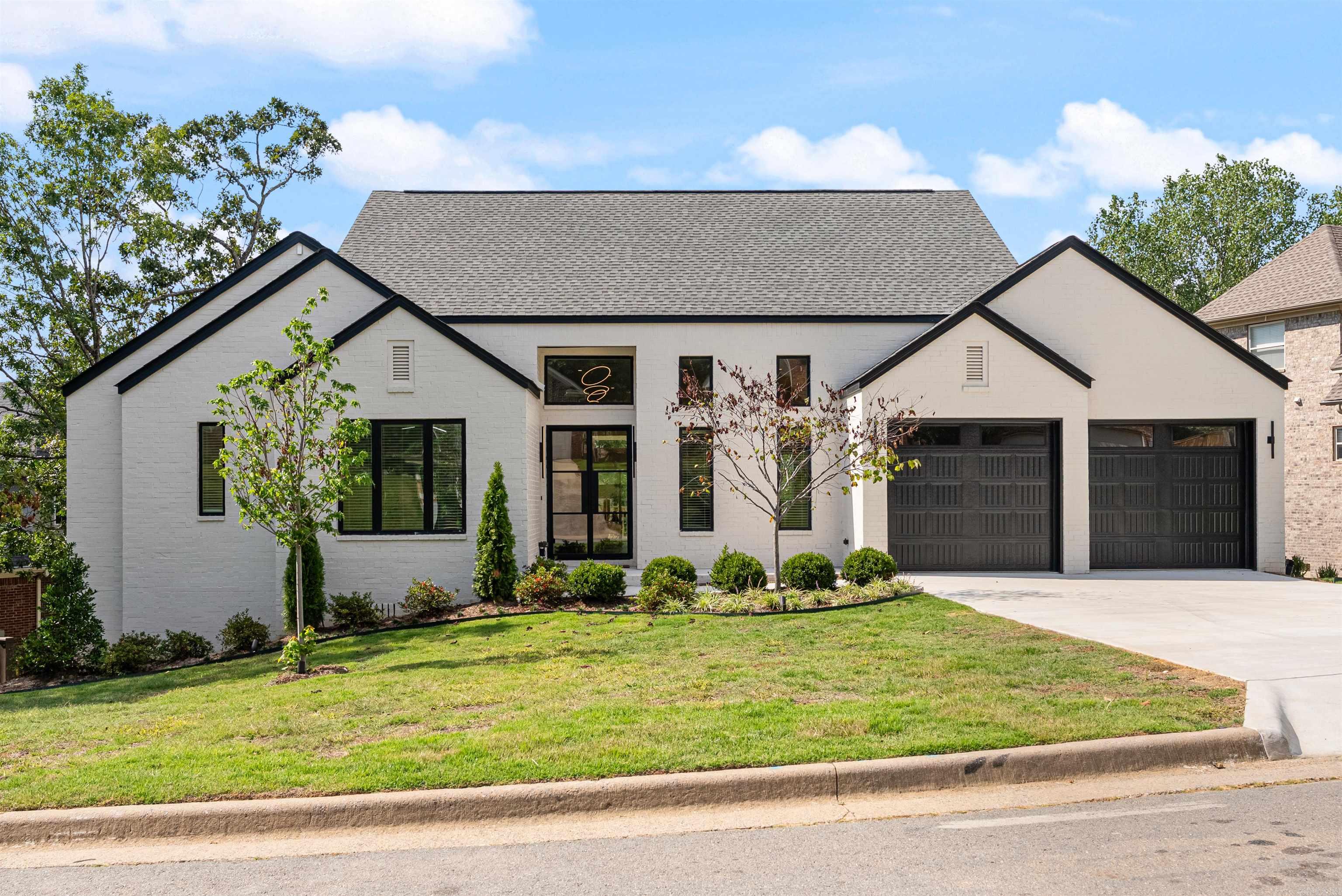 Tucked away in Chenal Valley, within walking distance to the neighborhood pool & park, this new construction home by Icon Homes was designed with high-end features and thoughtful details throughout. The exterior blends white brick and Hardie board siding with black accents for striking curb appeal with the home backing up to dedicated green space. Custom iron doors open to a bright foyer with white oak hardwood floors, 13ā ceilings, & expansive windows framing treetop views. The formal dining flows into a chefās kitchen with quartz countertops, a large island with bar stool seating, a pot filler, walk-in pantry, & planned GE Profile appliances (still customizable to buyer preferences). The kitchen opens to the great room with electric fireplace, wet bar with sink and beverage fridge, half bath, and sliding doors to a covered deck ideal for entertaining. The primary suite offers hardwood floors, spa-like bath with soaking tub, walk-in shower, and a large closet. Flexible spaces include 2 guest bedrooms (one used as an office) and a hall bathroom. Amenities: laundry room, designer lighting, window treatments, and a partially fenced backyard that backs up to dedicated green space.