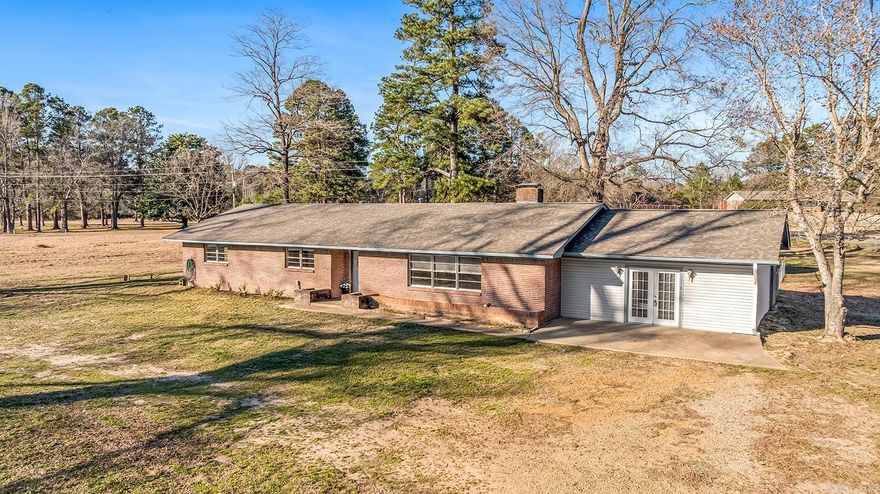 Located just outside the city limits of Texarkana, AR, this 3-bedroom, 2-bath home sits on 2.71 acres on a corner lot, offering space, privacy, and opportunity. The home features a large living room, fireplace, a kitchen with dining area, and a breakfast bar that works well for everyday living and entertaining. The enclosed, finished-out garage (flooring not installed) provides flexible space that could easily be used as an additional living area, playroom, home gym, or office. Recent updates include a new roof, new water heater, and fresh exterior paint, giving buyers a solid foundation to build on. Outside, a metal storage building remains with the property, along with additional storage space in the garage area. With plenty of land and room to customize, this property is ideal for a buyer ready to make it their own while enjoying a peaceful setting just minutes from town.