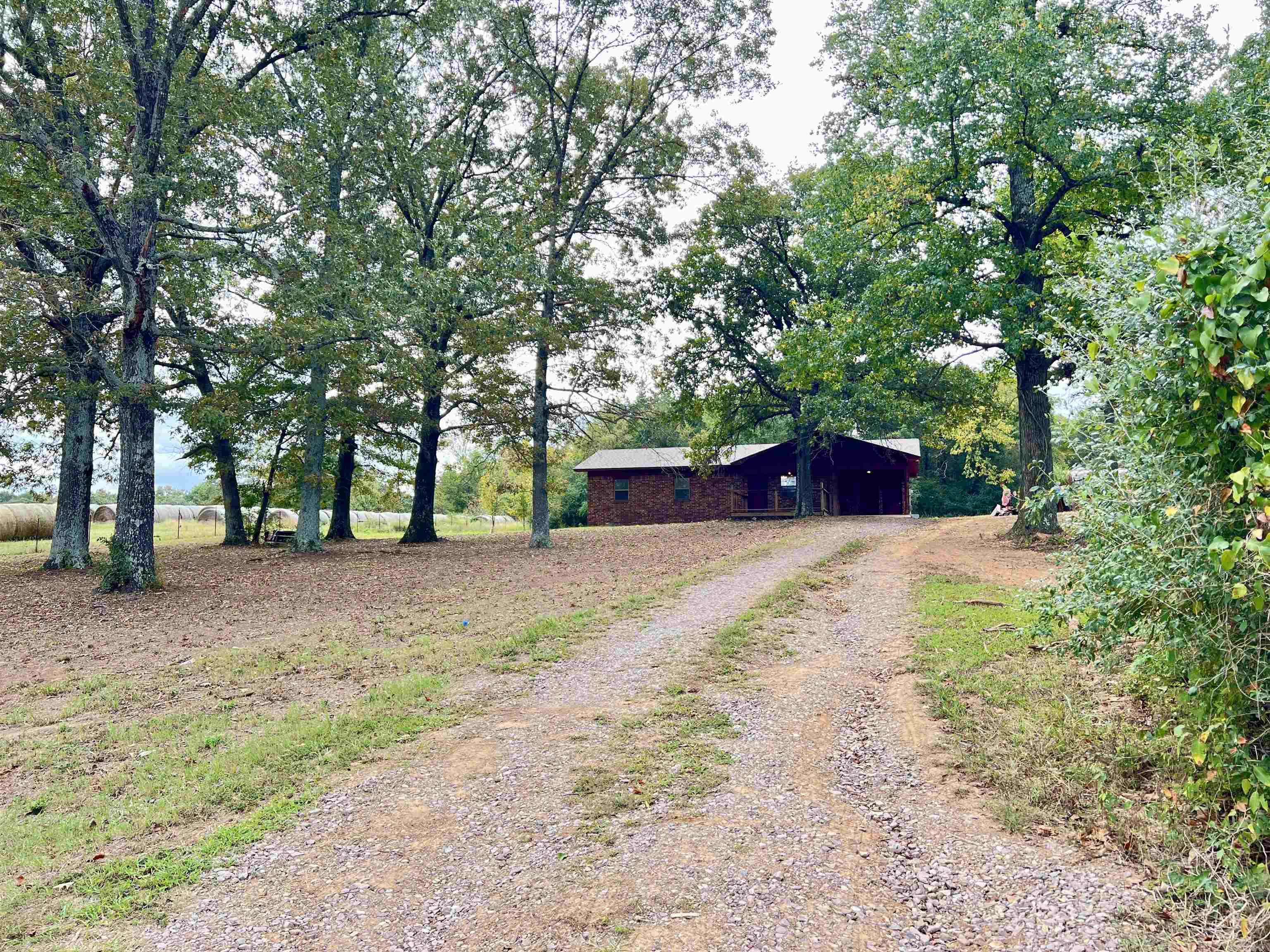 Enjoy the peaceful feel of being in the country, overlooking rolling pasture land, while still being close to the amenities of Morrilton and within 5 minutes of Interstate-40. NEW in 2024: Roof, HVAC, Water Heater, Laminate Flooring & Interior Paint. Seller is offering a $4000 Appliance/Carpet Allowance with acceptable offer, so the buyer can select their preferences in finalizing the updates. Primary bedroom has an en suite half-bath, kitchen/dining combo, separate laundry room. The home is on city water. Eligible for USDA Rural Development loan which offers qualifying individuals the opportunity to purchase with no money down. Seller is still finishing some updates & painting; Showings can be scheduled starting Oct. 7, 2024.