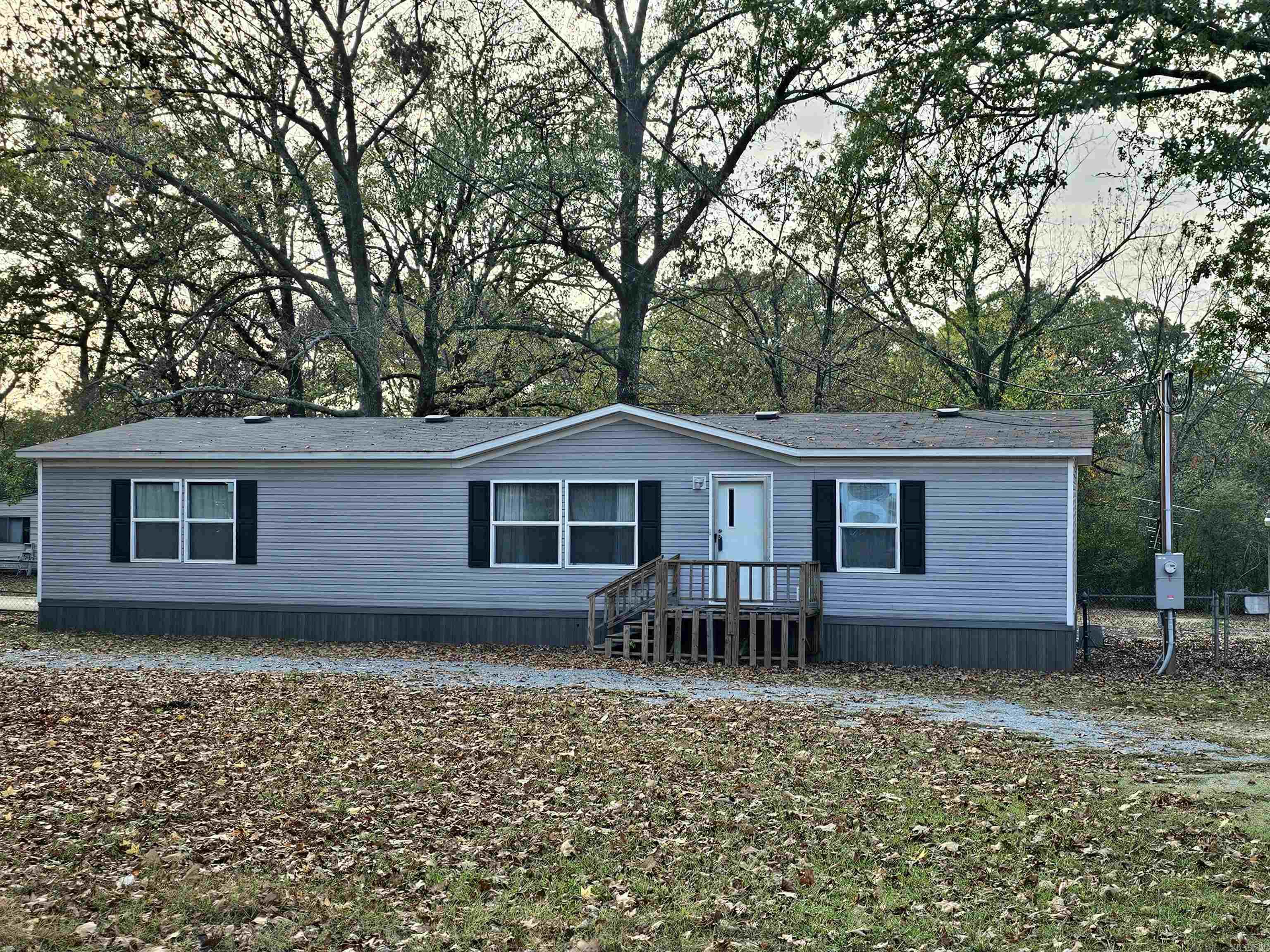 Looking for a little piece of country living near town...This is it. This is a 2 year old double wide mobile home situated on almost an acre level lot. You will love the open floor plan and beautiful luxury vinyl plank flooring. The vaulted ceiling makes the living area and kitchen feel even larger. The kitchen offers lots of cabinetry and an island. The primary bedroom is large and separate from the other bedrooms. All of the bedrooms have a walk-in closet with plenty of storage. This was 2 lots combined to make one large lot of .87 of an acre. It is also fully fenced with a storage building. Call today for a showing.