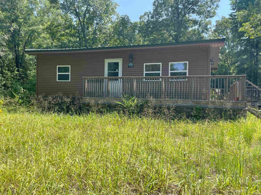 Rustic 4 bed 1 bath home set up as hunting retreat or VRBO. Built 2019 6 inch walls. High end laminate flooring, Granite Island in kitchen. Wired for high speed internet. Smart TV conveys. Plumbing for washer and dryer in crawl under kitchen floor. Large Deck mostly level and only 4 miles from public river access, & borders the National Forest. Mostly wooded 20 AC M/L. 960 SQ FT. $259,000