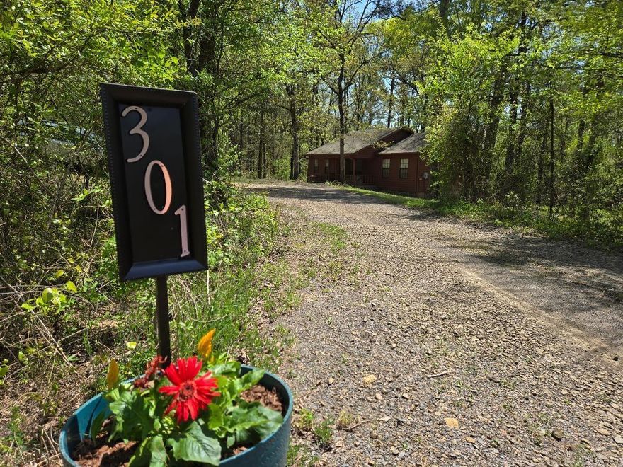 Tucked back in the woods is this log sided house with a private setting but just minutes to Hwy 292. Enjoy sitting on the back deck and watch the deer or go fishing in your pond! Home has new insulation under the house to help keep the utility bills low. Heat Pump was serviced in 2024. The wood log siding was stained in 2022 and looks brand new! This home has Fiber Internet through Wave and is all electric. The owner has taken great care of this home and has it ready to move into! Termite policy current through Delta. Outbuilding was built onsite and does stay with the house! Don't wait on this and call today for your showing!