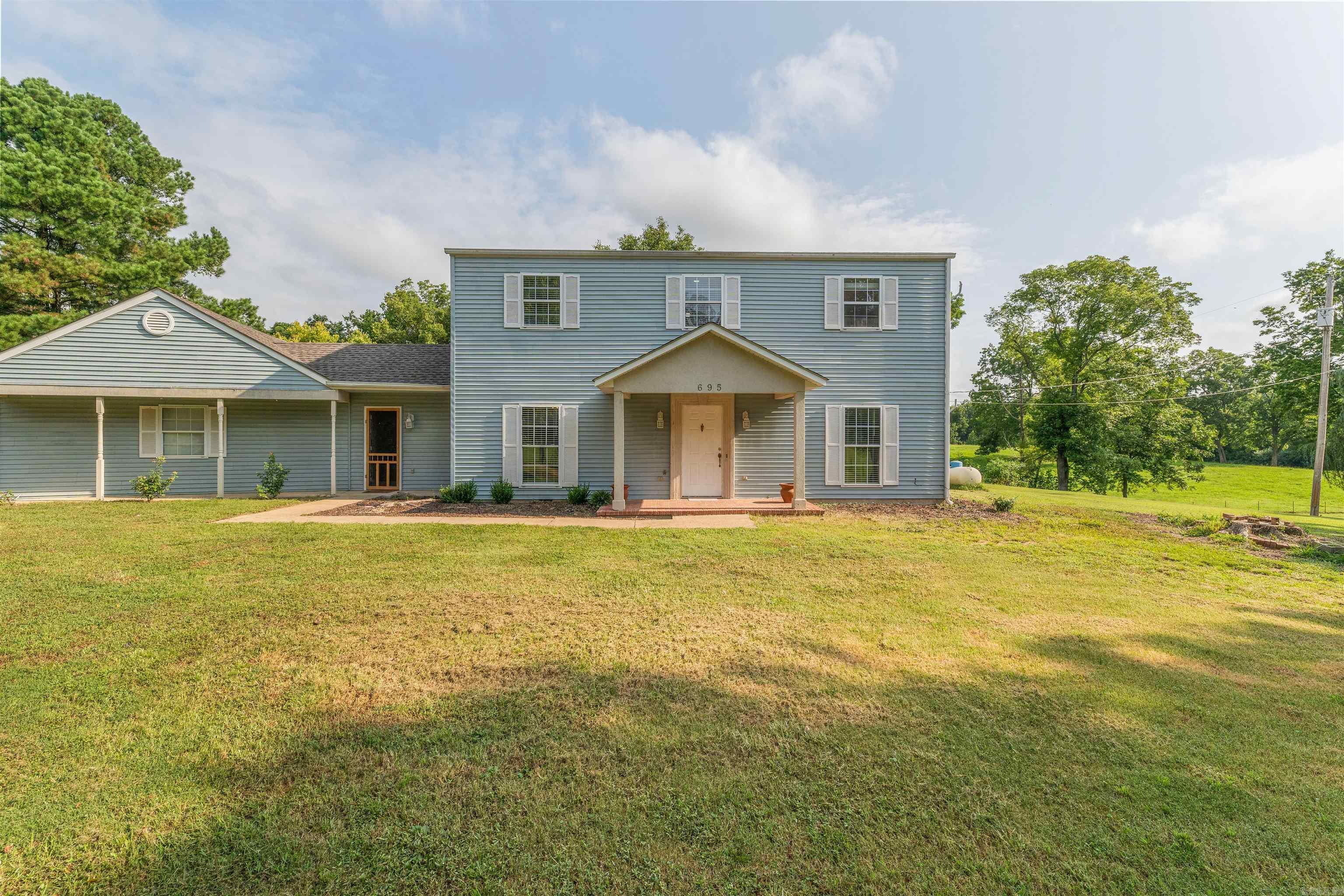 Enjoy peaceful and quiet country living in this nice rural home with a great location among the rolling hills and green pastures, a short commute to town and close to the amenities. Enjoy time outside on the back patio or working in the detached shop on the 1.35 acres of land with large trees and shading. Lots of updates including NEW Roof September 2023, NEW HVAC upstairs 2020 and downstairs 2023, NEW Flooring-carpet in bedrooms and vinyl plank in formal living area and master bathroom, NEW soaker bathtub and toilet in master bathroom, NEW shower heads in both bathrooms, NEW closet door in Master Bedroom, NEW Paint throughout the home, NEW blinds, NEW shop entry door, NEW screen door entry to sunroom/mudroom. You won't want to miss this one! Call for a showing today! (measuring is encouraged) No Sign in Yard
