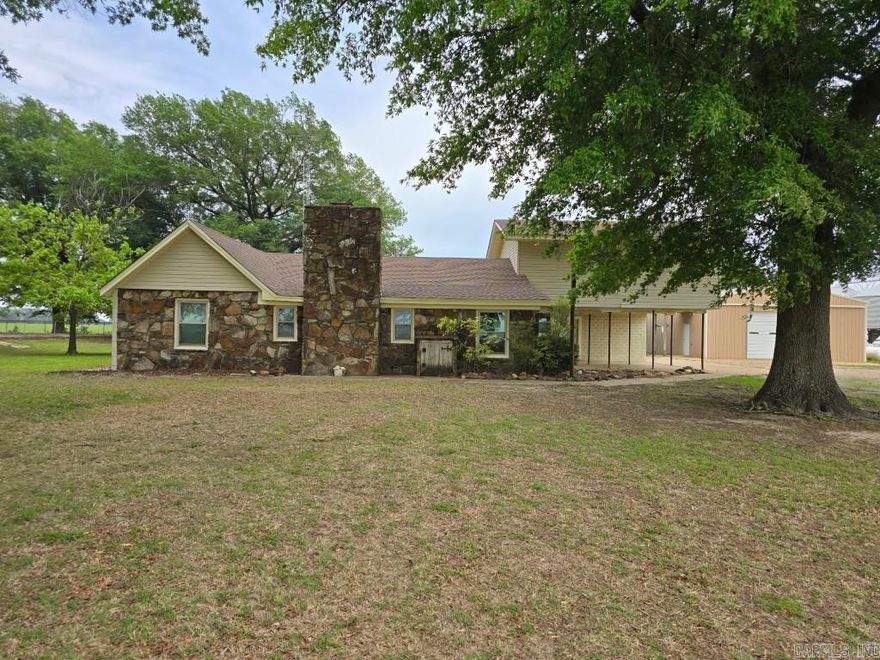 This home has had a new roof and new central h/a unit installed within the past 2 years. Wood burning fireplace, updated kitchen. appliances included. 32 x 40 shop building with RV cover (RV negotible). lower level features 3 bedroom, one bathroom, Family room, Kitchen,Dining and laundry. Primary Bedroom with full Bathroom upstairs. e-z lift for stairs.