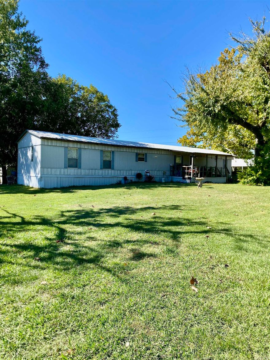 Well-kept 1995 manufactured home situated on 2.89 acres just on the outskirts of Clarksville! Enjoy peaceful country living with plenty of room for animals, a garden, or even crops with the convenience of a private well in addition to rural water. The property features large shade trees, a 45 x 25 workshop, two storage buildings, a newer 24 x 24 double garage with roll-up doors, and a double carport. All appliances convey—including the refrigerator, washer, and dryer—making this a move-in-ready opportunity. A storm shelter provides peace of mind, and the bonus add-on offers additional flexible space for hobbies. A perfect blend of comfort, functionality, and country charm just minutes from town!
