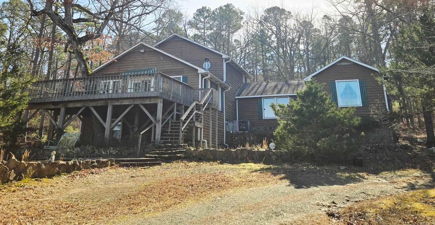 You’ll fall in love with this secluded retreat overlooking Drasco, Arkansas. Set on 20 acres, this 4,000-square-foot, three-story home offers space, privacy, and flexibility. The home features four bedrooms, with the potential for a fifth, and 3.5 baths. Two bedrooms are located on the lower level, two on the main level, and the entire top floor is an open space with a private master bath, making it ideal for a primary suite, studio, or bonus living area.  The open-concept living, dining, and kitchen area creates a welcoming central gathering space and opens onto a large balcony overlooking the surrounding acreage. A dedicated library or office provides a quiet place to work or unwind, while the wood-burning stove adds warmth and character. An open game room offers additional space that can easily be adapted for a variety of uses.  The home sits on approximately 10 acres along a ridge, overlooking an additional 10 acres with its own well and septic already in place. It’s a prime location for a second home, guest house, or future expansion.  Peaceful, private, and full of possibilities, this property is perfect for those seeking country living with room to breathe.