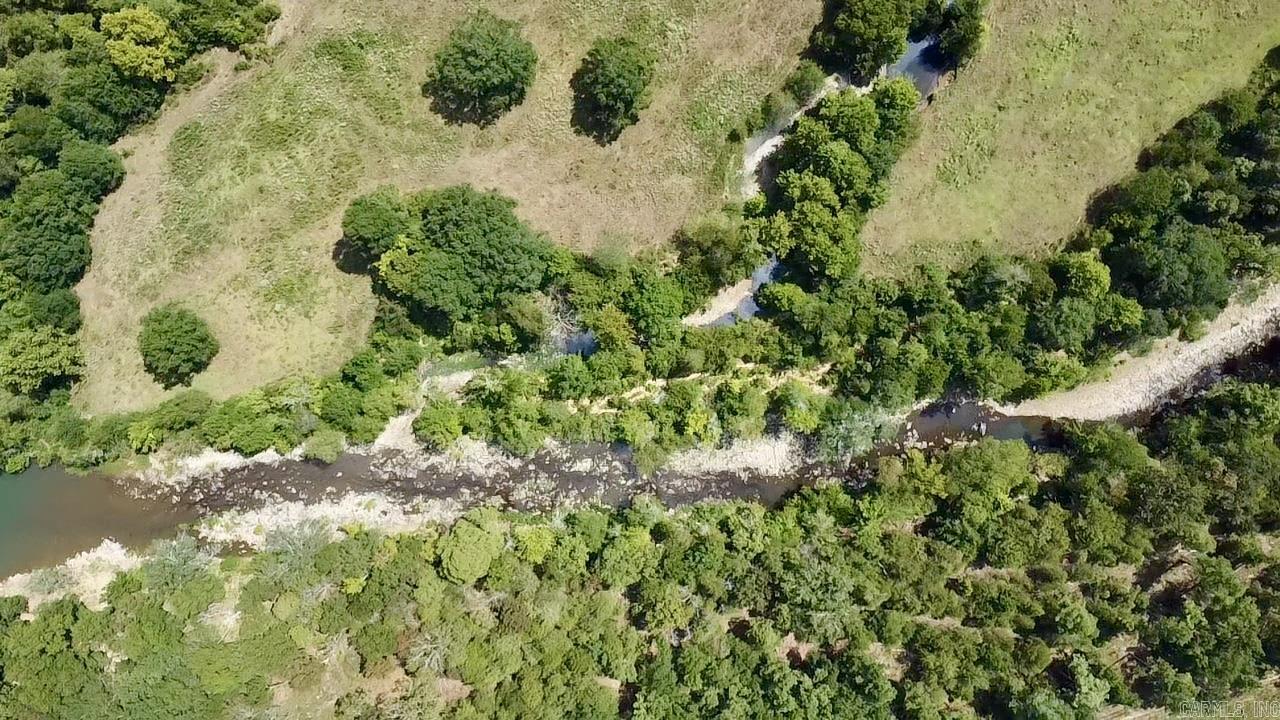 3 Acres on Little Piney Creek. Rare find! This 3-acre tract offers nearly 300 feet of frontage on Little Piney Creek, elevated for gorgeous views. Mostly wooded with large trees, natural rock steps lead down to the water. Enjoy gated private access, plus a community easement for easy canoe and raft launch. Electric is less than 1,000 feet to the property line. New survey in place. Build your weekend cabin getaway or forever home in this beautiful private setting.
