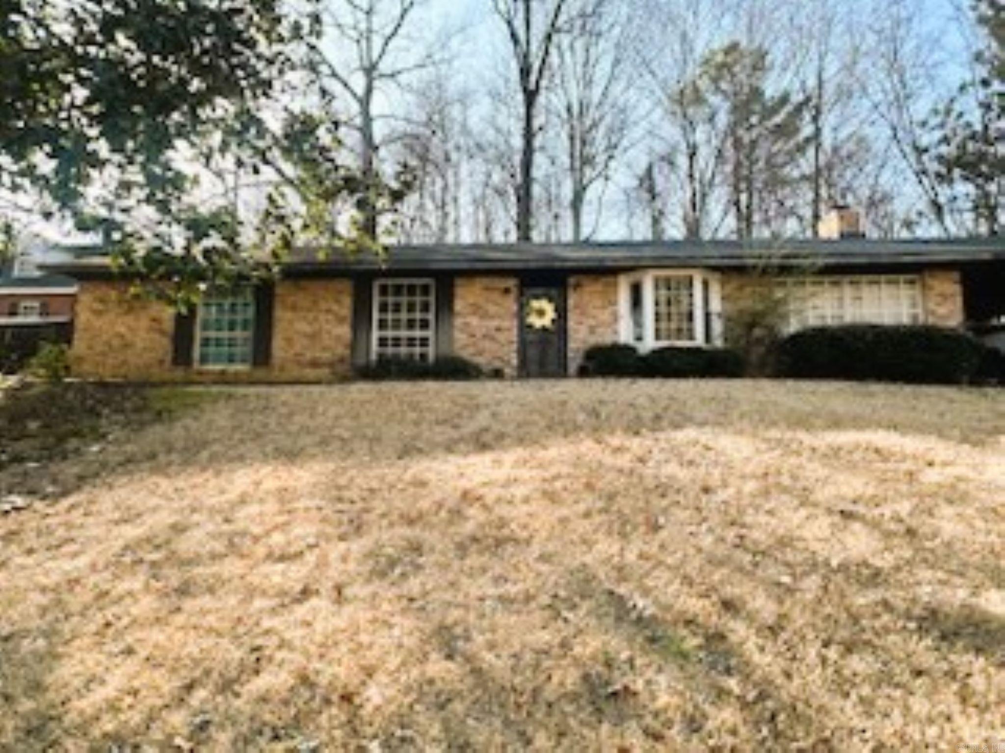 Welcome to this charming three bedroom brick house with a perfect blend of classic and modern comfort with a traditional wood burning fireplace as focal point of the living room. Spacious open floor plan that is great for everyday living. Two bathrooms with ample space and spacious laundry area. The kitchen features cabinetry with plenty of space. Additional highlights include a large backyard with two car carport and drive.