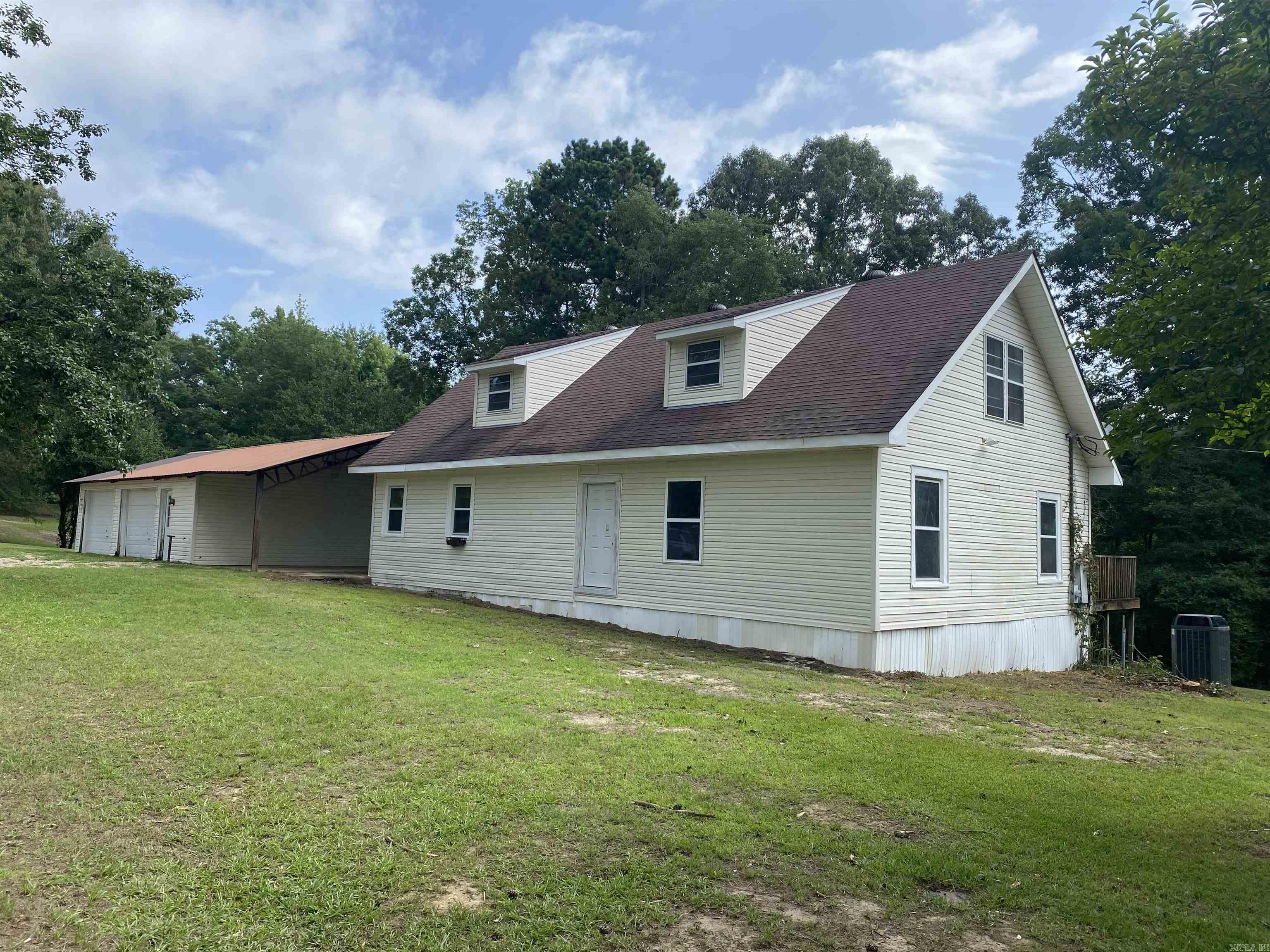 A home with good bones is one that you can do anything with! This fixer upper is sitting on a beautiful 4.00+/- acre lot with a pond and lots of street frontage. It is ready for you to finish out in your own image and has so much potential. Look at the pond from the large back deck that the home has, drink your coffee and appreciate the quiet that comes from living in rural southwest Arkansas. The property also includes a spacious 2 car garage and a 1 car carport. Schedule your private showing today!