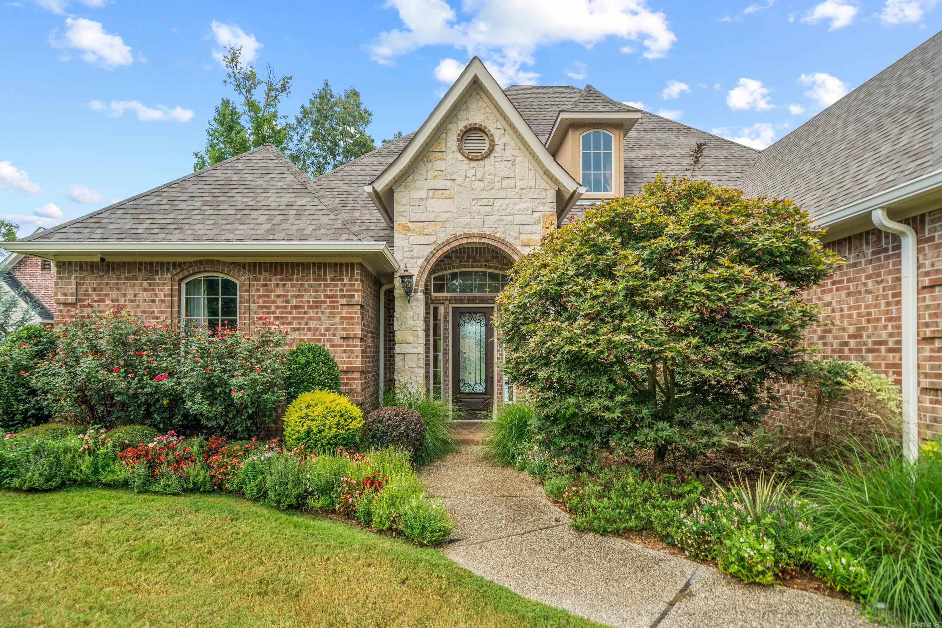 Experience luxury lakeside living in this exquisite home on the shores of Lake Hamilton. As you enter, you’re welcomed by hand-scraped hardwood floors that lead into a spacious den and formal dining room, perfect for hosting gatherings. The heart of the home is the chef’s kitchen, which boasts beautiful granite countertops, custom cabinetry, and top-of-the-line appliances, making it a culinary dream. Step through the 16-foot panoramic doors that lead to the expansive outdoor living area, where you’ll find a fully equipped outdoor kitchen and a heated in-ground swimming pool, and hot tub ideal for year-round relaxation. The double-stall boat dock, surrounded by meticulously landscaped grounds, offers convenient lake access and stunning views. With three zoned air-conditioning units for customized comfort, this home offers both luxury and convenience, providing the perfect retreat on Lake Hamilton. This well cared for home is move in ready for you to create the lake life you have been dreaming of.
