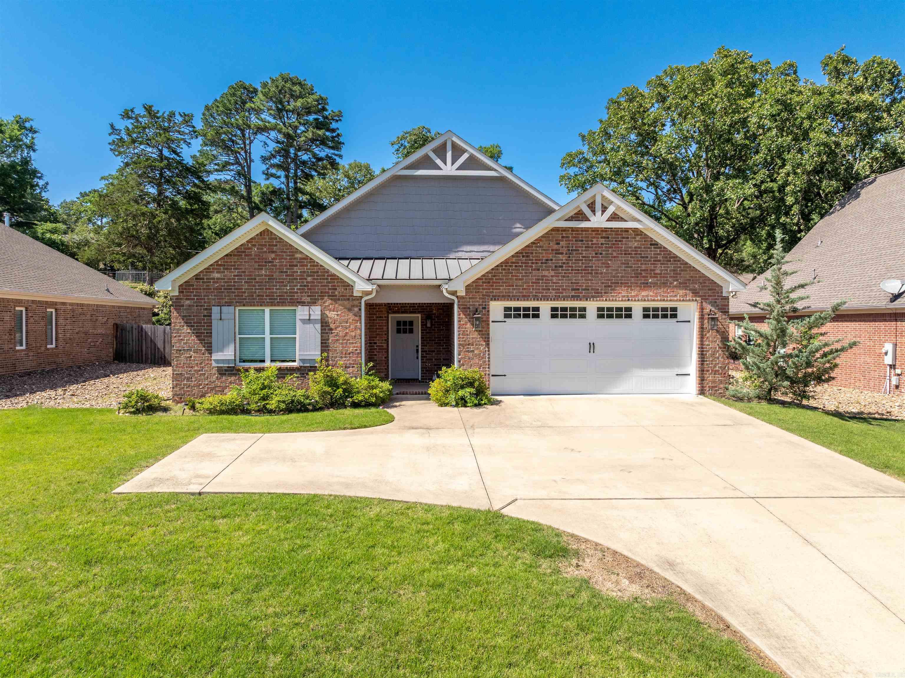 Crafted with care in 2018, this charming, all-level home offers a low-maintenance lifestyle in a prime location! Inside, you'll find thoughtful features like a large pantry and laundry room, crown molding, and built-ins in the living room. The cozy fireplace with gas logs adds warmth and ambiance, while the covered patio provides a perfect spot to relax or entertain. The primary bathroom boasts a spacious, beautifully tiled shower. Located just half a block from National Park Medical Center and minutes from shopping, Oaklawn Racing Casino Resort, and the Lake Hamilton boat launch, this home combines comfort with convenience. Don't miss out—schedule your private tour today!