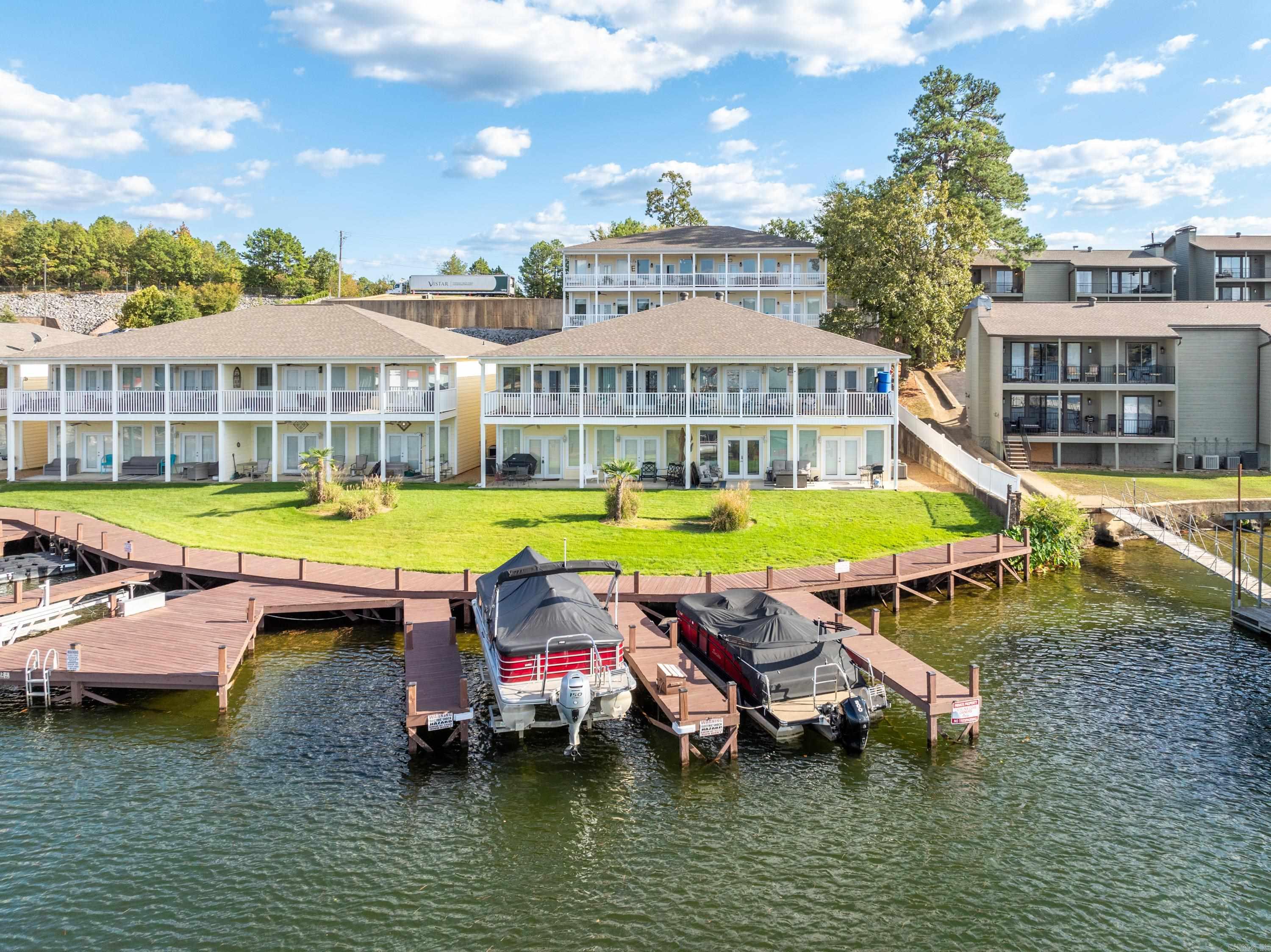 INVESTORS TAKE NOTICE - BEAUTIFULLY UPDATED CONDO RIGHT ON THE WATER! Welcome to your weekend retreat on beautiful Lake Hamilton. This well-appointed 2 bedroom 2 bath condo can be used as a short-term vacation rental. BOAT SLIP INCLUDED. Watch the fireworks from the large patio in this 1,500 sq ft condo that includes refrigerator, washer and dryer. Also has a bonus area with room for a full size bed perfect for extra guests. Lots of updates including NEW flooring throughout, NEW water heater, NEW Hvac, NEW refrigerator, NEW dishwasher, and NEW ice maker. Convenient 7 South location close to everything - located less than 5 miles to Oaklawn Racing Casino Resort and about 6 miles to downtown Hot Springs and Bath House Row. . Close to shopping & restaurants. This unit sits right on the water with AMAZING main channel views. This one is a must see!
