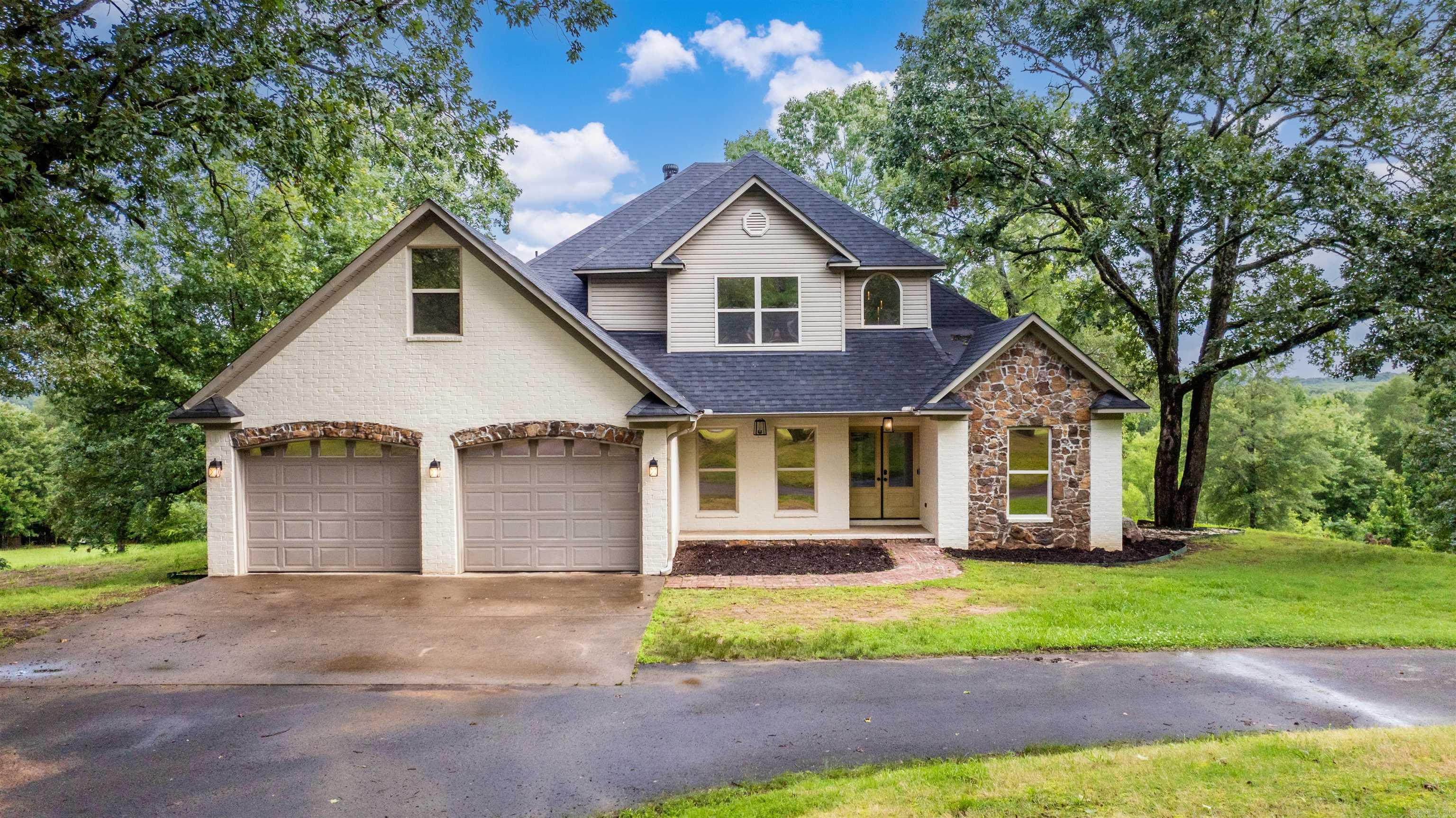 Welcome to your dream home—where nature, space, and style come together on 3.56 stunning acres that back up to a protected federal nature preserve complete with a tranquil creek. Built in 2005, this beautifully updated 4-bedroom, 2.5-bathroom home offers 2,800 sq ft. The spacious main-level primary suite provides convenience and privacy, while three additional bedrooms are tucked upstairs. The dramatic living room features a soaring vaulted ceiling, eye-catching fireplace, and a wall of windows that fill the home with natural light and breathtaking views. Step outside onto the brand-new back deck—perfect for soaking in the peaceful surroundings. Inside, you'll love the updated finishes including all new lighting, fans, and appliances (2023), as well as a new front door and fresh exterior paint. The lower level features a brand-new HVAC system and a new roof adds long-term peace of mind. A separate shop and office space with its own driveway offers endless potential—ideal for hobbies, a home business, or additional storage. Don't miss this rare combination of modern updates, scenic beauty, and functional space—schedule your private tour today!