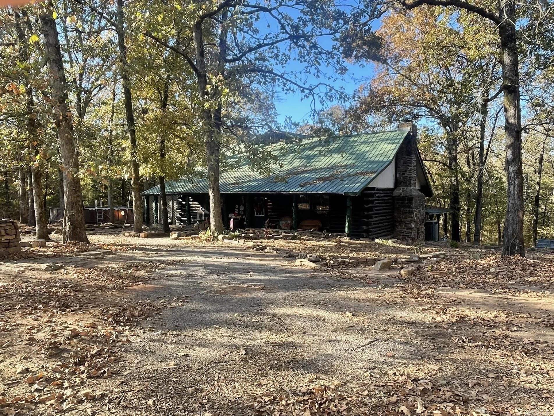 Welcome to your dream retreat! This beautifully crafted 4-bedroom, 3-bath log cabin offers the perfect blend of rustic charm and modern convenience, all set on a private 2.5-acre lot surrounded by nature. From the moment you step inside, you’ll be greeted by soaring wood-beamed ceilings, a warm and inviting stone fireplace, and generous natural light that pours through large windows. With 2,782 square feet of living space, there's room for everyone to relax and enjoy the peaceful setting. Set back from the road and surrounded by mature trees, this home offers privacy, serenity, and the true feel of country living, while still being a short drive to town. Schedule your showing today!
