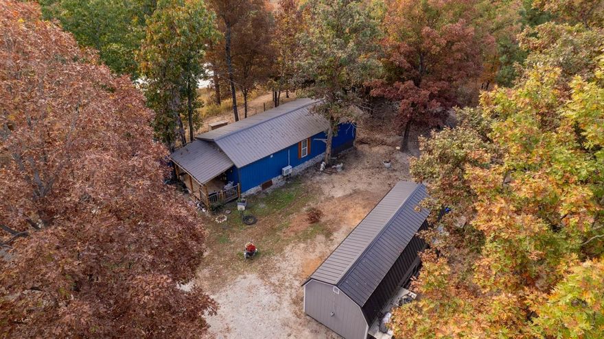 OZARKS HOBBY FARM AND COUNTRY HOME FOR SALE VIOLA AR  Property located at 1674 Echowood Cir, Viola, AR. This country home sits on 6.77 acres just off of Hwy. 62/412. The home has approx. 640 sq. ft. of living area with 1 bedroom & 1 bath. Rustic interior finish with wood stove, range, refrigerator and a mini split heat & air system. Also included is a wood deck with a covered cook shack for your outdoor cooking. Fire pit and koi pond. Rural water and septic system. 2 storage sheds. The newest is a 14 x 30 with electricity and could easily be converted to living quarters. Most of the property is fenced for goats and sheep. Large pond that is stocked with catfish. Also includes a small pond. Plenty of wildlife including deer. Lake Norfork is just a short distance.