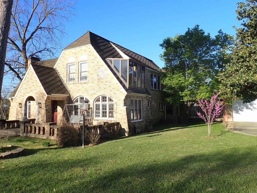 Storybook 'Older' BRICK HOME (2-levels) with BRAND NEW, TRIPLE GARAGE on slab with concrete, double driveway PLUS AN EXTRA BUILDING LOT with street frontage.  This Property fronts S. 9th Street & it completely 'fronts/backs-up' to the NEW S. 10th STREET (also known as Hwy. 67 South).  Architecturally, this home is 'over-the-top' beautiful!  The main-level LIVING ROOM ceiling soars upward toward the roof-line! There is a front/corner sunroom with 2 walls of windows (part of the original floor plan).  There is a formal DINING ROOM & an everyday DINING AREA adjoining the remodeled KITCHEN.  Separate laundry.  Impressive STAIRWAY with lots of moulding.  2 BEDROOMS on main-level.   Luxury private bathroom in Primary Bedroom suite --- along with walk-in closet.  Guest half-bath.  3rd & 4th BEDROOMS are upstairs with nice HALL BATH.  The present Zoning of this HOME & EXTRA LOT is Residential Multi-Family (MF).  Immediately South of this Property is Zoned General Commercial (GC).  Immediately North of this Property is Zoned Neighborhood Commercial (NC).  Possibilities are endless!  Live in this fabulous, older HOME and 'work' at home, if you wish.  Oh my gosh, be still my beating heart!