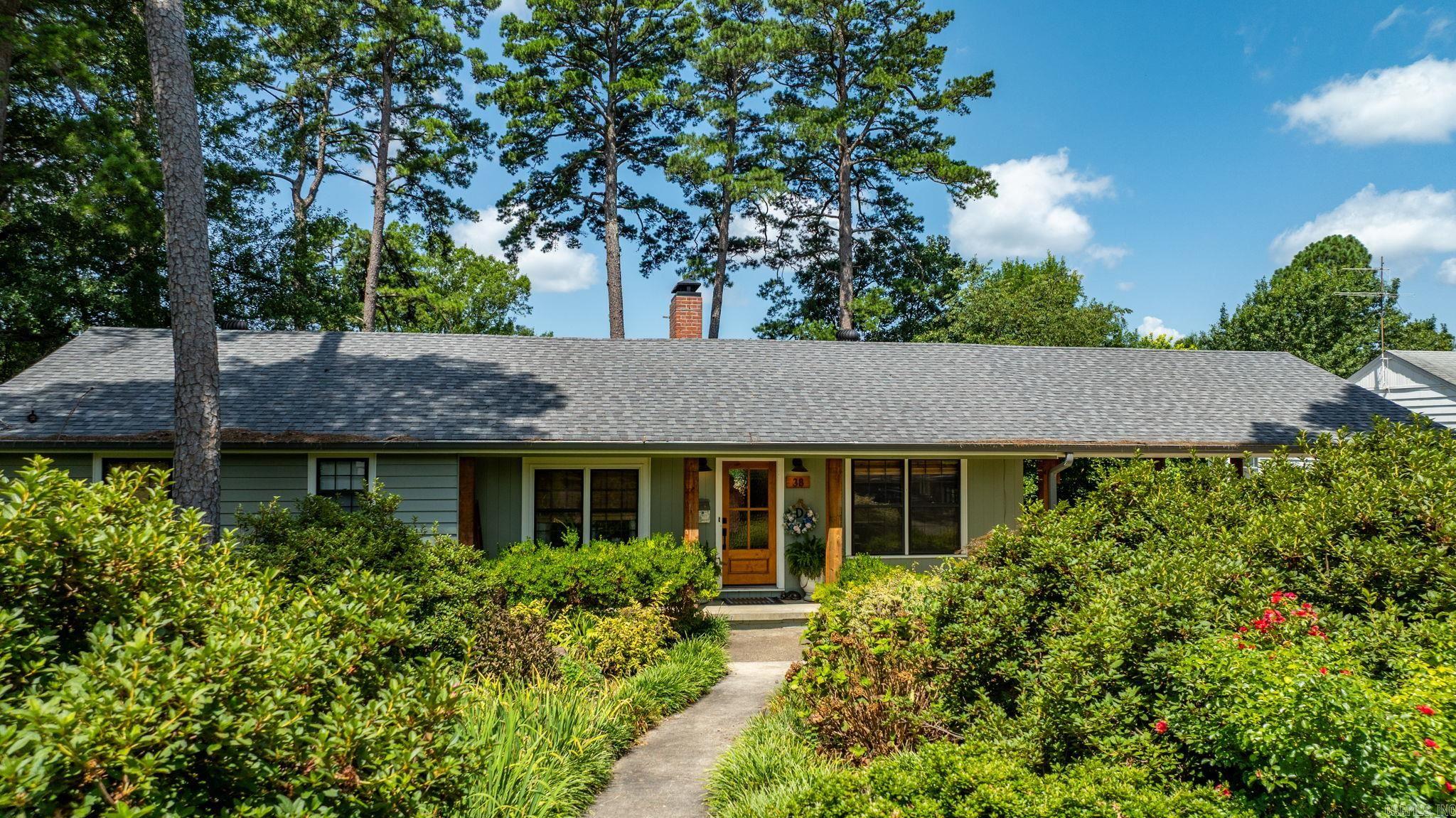 Welcome to 38 Pine Manor Drive, a charming Mid-Century gem with modern upgrades on a quiet midtown street. Step into this beautifully remodeled classic home, perfectly blending timeless character with contemporary comforts. Situated in a well-established, friendly neighborhood, this residence offers the best of both worlds — vintage charm and modern luxury. The heart of the home is the stunning open kitchen, fully renovated in 2020 with new appliances including an induction stove, ample cabinetry, and a large island ideal for meal prep and entertaining. Site-finished hardwood floors flow seamlessly throughout the main living areas, adding warmth and elegance. The spacious primary suite features a large closet with ample storage, updated bathroom with elegant finishes and large laundry room convenient to the space. Relax or entertain in the new screened-in porch featuring a cozy outdoor fireplace — a perfect spot for year-round enjoyment. Downstairs is one more bedroom, bath, and 400 square foot, newly built, heated & cooled bonus space--perfect for shop, hobbies, or even extra living space. We would love to welcome you home to 38 Pine Manor Drive! Agents see remarks