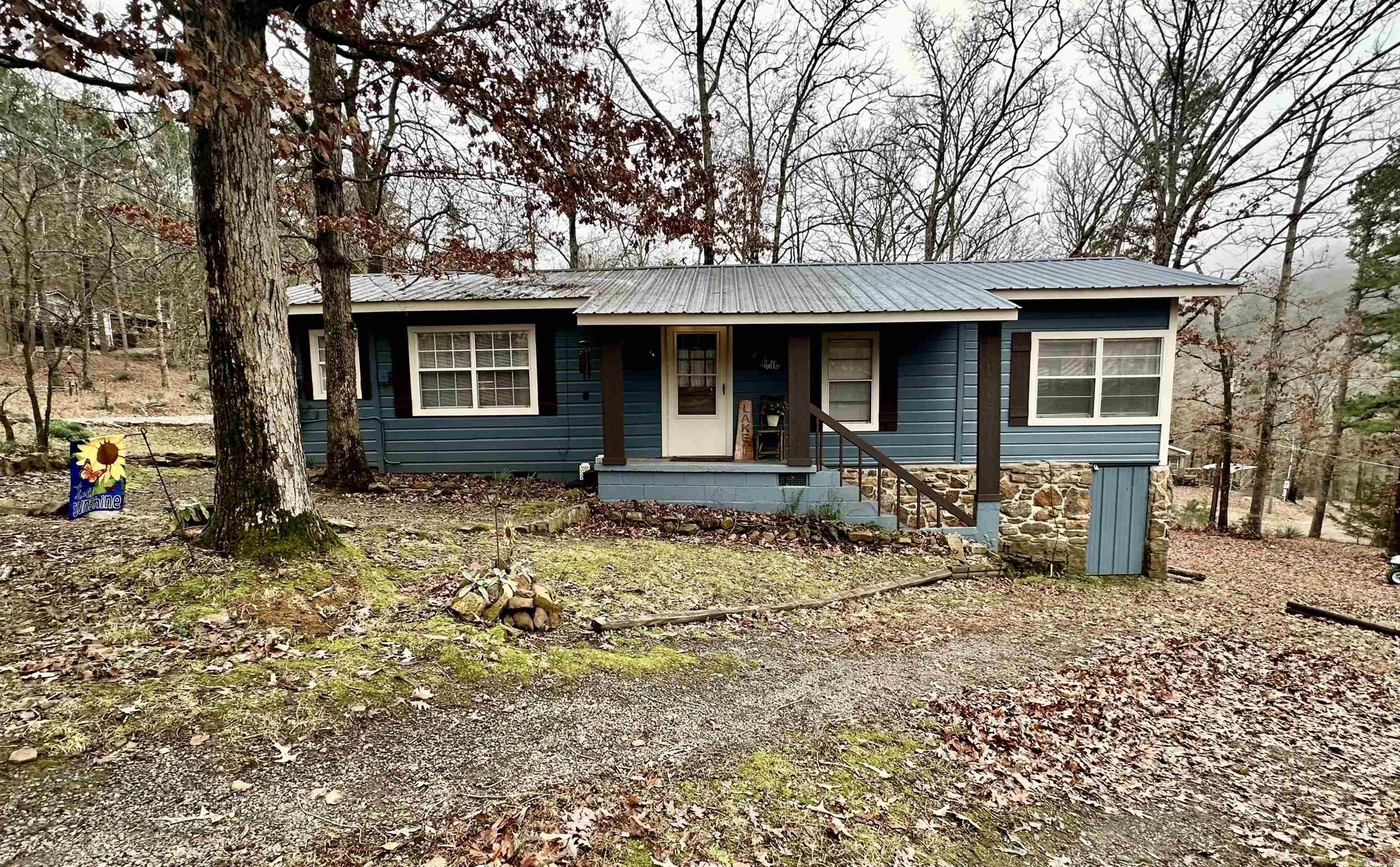 Escape to tranquility with this charming retreat in Drasco, AR! Located just across the street from the shimmering lake, this move-in-ready home offers breathtaking views and a serene, quiet neighborhood. Perfect for nature lovers, the property features a relaxing creek in the backyard, a spacious sunroom for enjoying the scenery year-round, and a large back porch ideal for entertaining or unwinding after a day on the water. The home is partly furnished, including an extra refrigerator and ice maker, blending comfort and convenience. Current owners installed a Panasonic split unit in the living room that provides heat and air. The community boat ramp ensures easy access to all your lake adventures. Whether you’re looking for a weekend getaway or a permanent residence, this gem offers it all. Don't miss the chance to make this peaceful retreat your own!