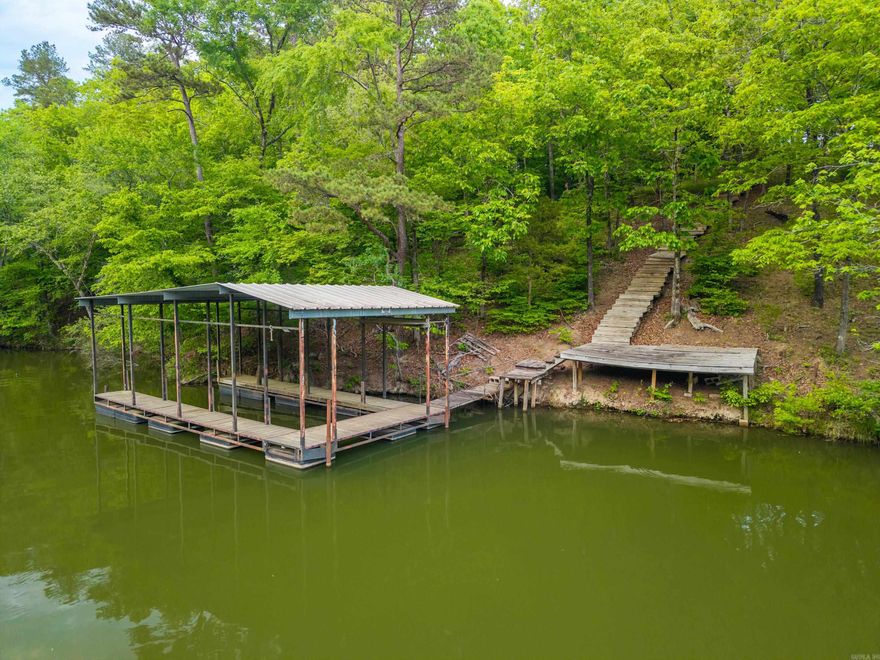 Private, serene lakefront setting on Lake Catherine with 249 ft of shoreline frontage. This 1.38-acre property offers the perfect blend of seclusion and convenience just 3 miles to Lakeside School and 6 miles to Neighborhood Walmart Marketplace. This lot is ready to build your dream destination home with all utilities in place and a prepared pad for construction. Enjoy the added bonus of a covered boat slip and RV included, ideal for living on-site while building your dream home. Great central location with easy access to nearby amenities.