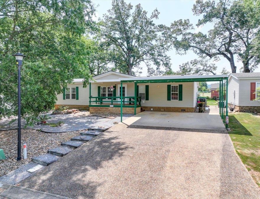 Well-Maintained Modular Home with Modern Upgrades minutes to Lake Hamilton   This 3-bedroom, 2-bath modular home offers over 2,000 sq. ft. of comfortable living space with a permanent foundation. Features include luxury vinyl flooring, a natural gas fireplace, spacious eat-in kitchen with abundant storage and pull-out drawers, and a fully enclosed 434 sq. ft. solar-screened back porch. The master suite has dual closets plus extra storage, a separate mini-split AC for added comfort, and a full bath.  Recent updates include a 2023 roof, AC unit, and heat pump. Exterior highlights include Chattahoochee River rock flooring on both porches, a fenced backyard, motion detector lights, double carport, and ramp access.  Located in a 55+ community with low POA dues, saltwater pool, clubhouse, recreation room, and year-round social activities.