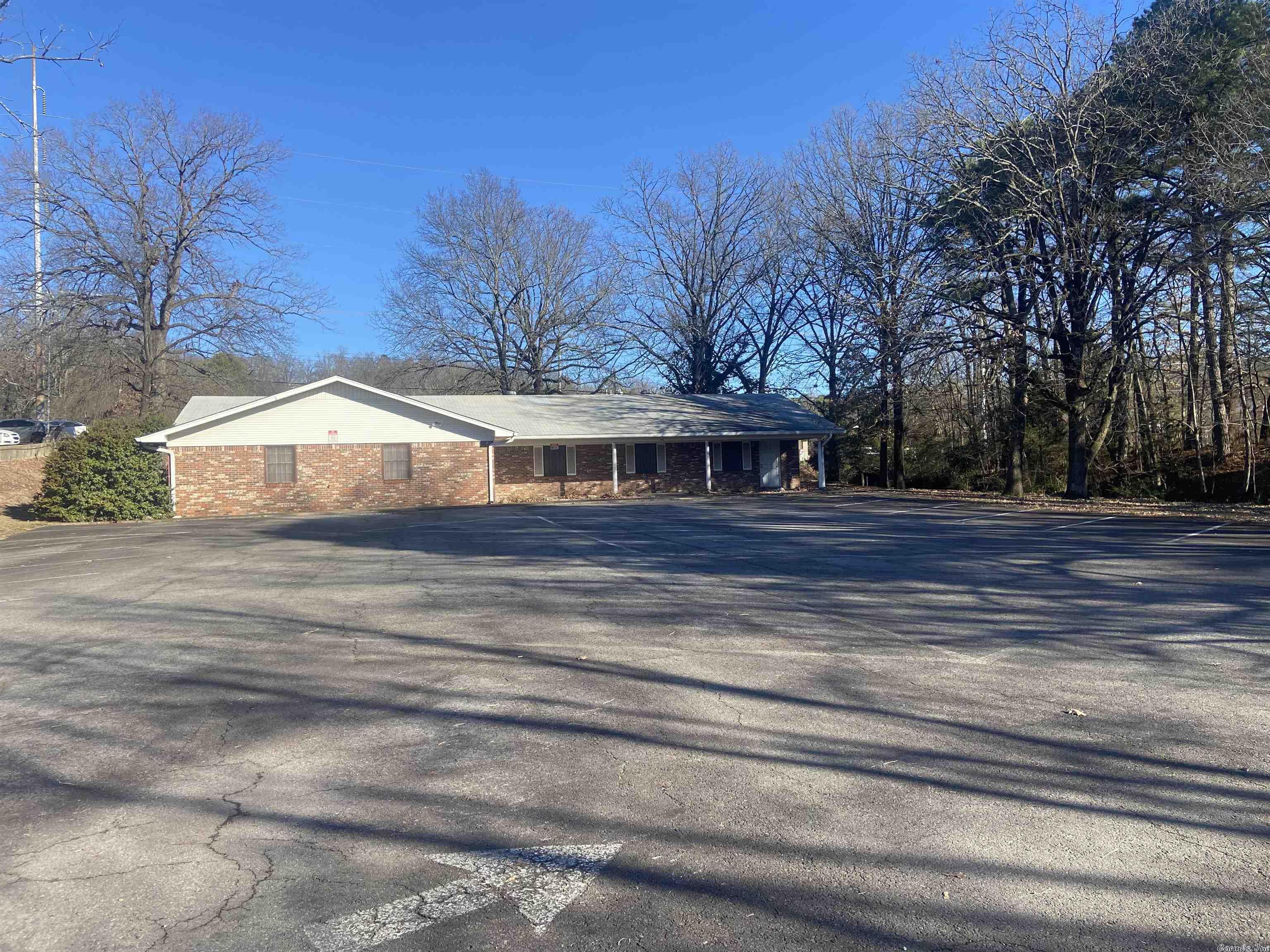 GREAT LOCATION FOR BUSINESS/FAST FOOD, ETC WITH RODNEY PARHAM AND MARKHAM FRONTAGE...170' frontage on Markham and 90' frontage on Rodney Parham (refer to survey) .91 acres per county currently zoned R-4 (Possibility of 2 residences) The South side of the property has a large parking lot marked with 26 spaces. The 3188 building has been used as a clubhouse that has been zoned residential since 1964. The building interior is not designed for residential use (refer to photos). The structure has 3 large meeting rooms, a full kitchen, a double stall bathrooom and 1/2 bath plus plenty of storage. Based on location, rezoning should not be an issue. Commercial buyers should include rezoning as a contingency to the purchase. Per Department of Transportation, the traffic count is in attached documents. A small creek runs the entire length of the property on the East side of property. No Seller Disclosure - Sq. Ft. from Assessor.