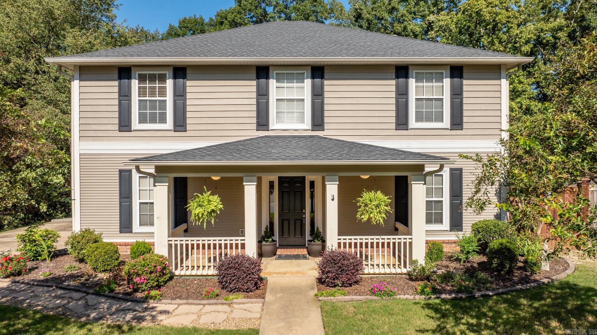 This stately home has the features to check the boxes for your next home! Drive up and enjoy the extra landscaping, beautiful details, and covered front porch. This one truly has stunning curb appeal. Step inside to freshly painted walls and find a formal dining, kitchen, breakfast bar and table area, plus living w/fireplace and guest half bath downstairs. Upstairs are four generously sized bedrooms plus spacious sitting area at the top of the stairs with built-ins, perfect for a mini office or play space for the kiddos. The back patio is also covered and looks out onto a lush green landscape, which also boasts a full shop with garage door for all your equipment and hobby needs, plus fire pit area. Check it out, fall in love, and make it your own!