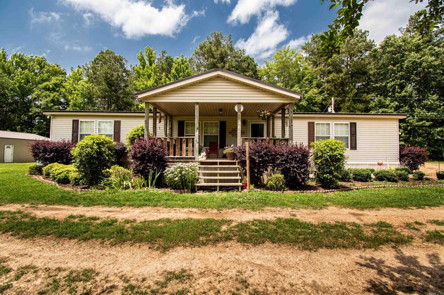 This very spacious modular home is settled onto the back corner of the property and looks over a pond. The home is landscaped and has a front porch to enjoy looking over the pond, and also an attached covered parking area in the back to keep you out of the weather. All of the bedrooms are big, with big walk in closets. The primary bathroom has a big walk in shower and a soaking tub. There is also a shop on the property that is wired. Having roughly 12 acres just 3 miles from downtown and college seems almost too good to be true.