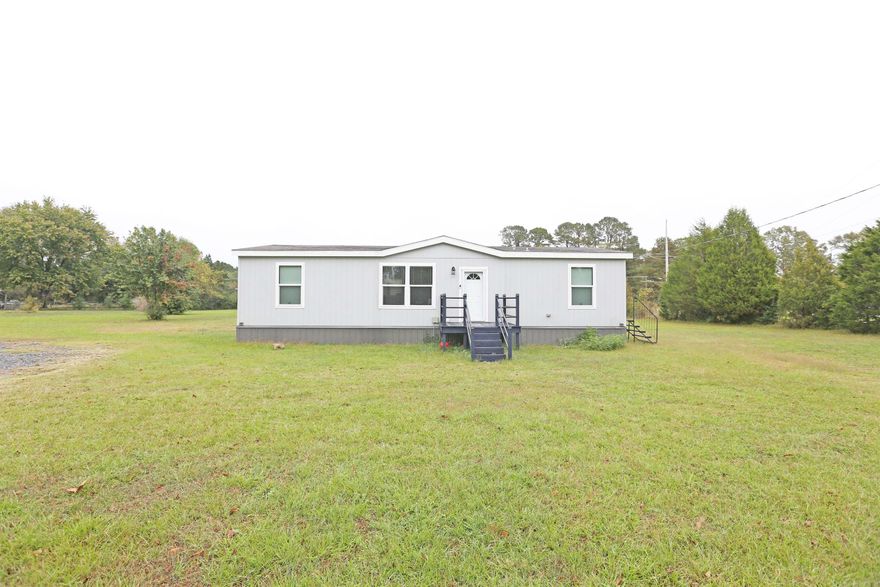 Welcome to peaceful country living at 13714 Highway 270 in Poyen, Arkansas. This beautiful 2024 Jessup home features 3 bedrooms and 2 baths and sits on 1.25 acres of serene, open land. The property offers the perfect blend of modern comfort and rural charm, with an all-electric design for efficiency and low maintenance. Inside, you’ll find a bright, open layout filled with abundant natural light that enhances the home’s inviting atmosphere. The spacious living and kitchen areas are ideal for gatherings or quiet evenings at home, while large windows frame the scenic countryside views. Step outside to enjoy the covered back porch, perfect for relaxing, sipping morning coffee, or watching sunsets in the peaceful surroundings. With plenty of space for gardening, outdoor activities, or simply enjoying the quiet, this home offers the perfect setting for anyone seeking a modern retreat in a tranquil rural community. AGENTS SEE REMARKS.