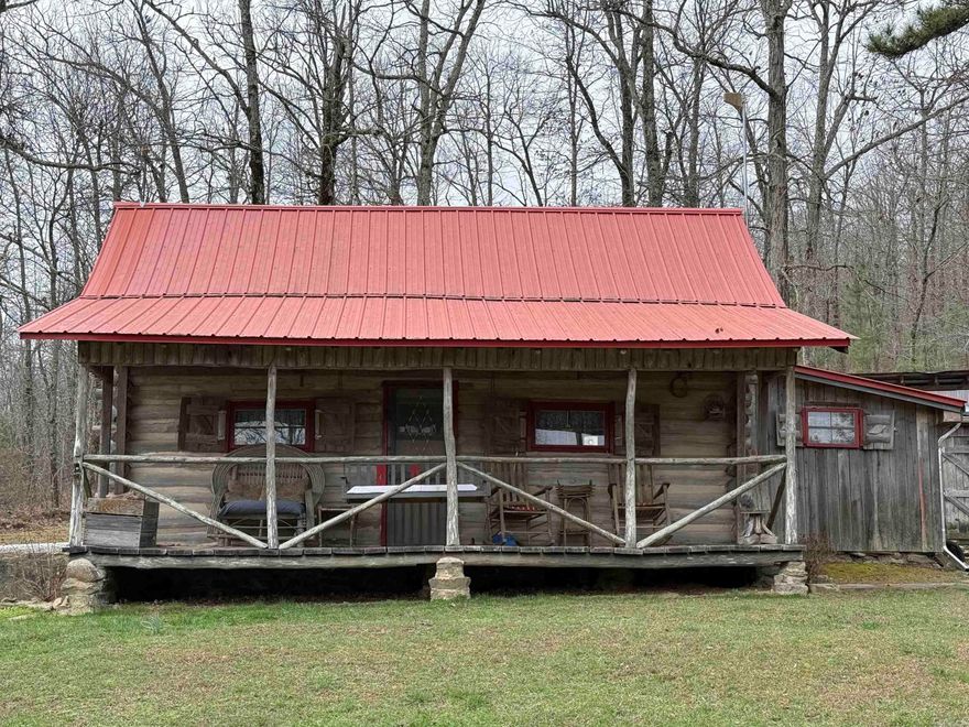 20 +/- wooded acres in Leslie, AR with Hurricane Creek flowing through the property. Features a 667 sq ft log cabin with rock fireplace designed for heat efficiency, 1-bedroom, spacious living area, kitchen, and full bath with rock shower. Covered walkway connects to laundry, wood room, and carport. Property includes public water, electricity, high-speed fiber internet, plus a well with hand pump. Improvements include a 16x24 barn with loft and side storage, greenhouse, fenced garden, chicken coop with covered run, and fenced area for small livestock. Additional living spaces include the “Studio Cottage” with full bath and efficiency kitchen, the creekside “Lean-to Cabin” with screened sleeping area, and a “Dry Cabin” with bed, wood stove, and writing desk. Ideal for homestead, recreation, or investment.