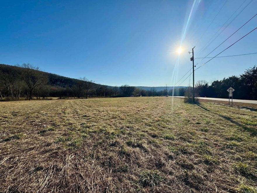 Prime 10-Acre Commercial Property with Highway Frontage – Near Downtown Mountain View! Excellent opportunity to own 10 acres of commercial land with high-visibility highway frontage, located just one mile from downtown Mountain View. This property offers utilities available at the road, making development seamless for a variety of business uses, including retail, hospitality, office space, or mixed-use projects or request city council. The land features a level to gently rolling terrain, minimizing site preparation costs. Its strategic location ensures easy access, strong traffic exposure, and proximity to an expanding economic area. Don't miss this rare investment opportunity in a growing market—schedule a site visit today!