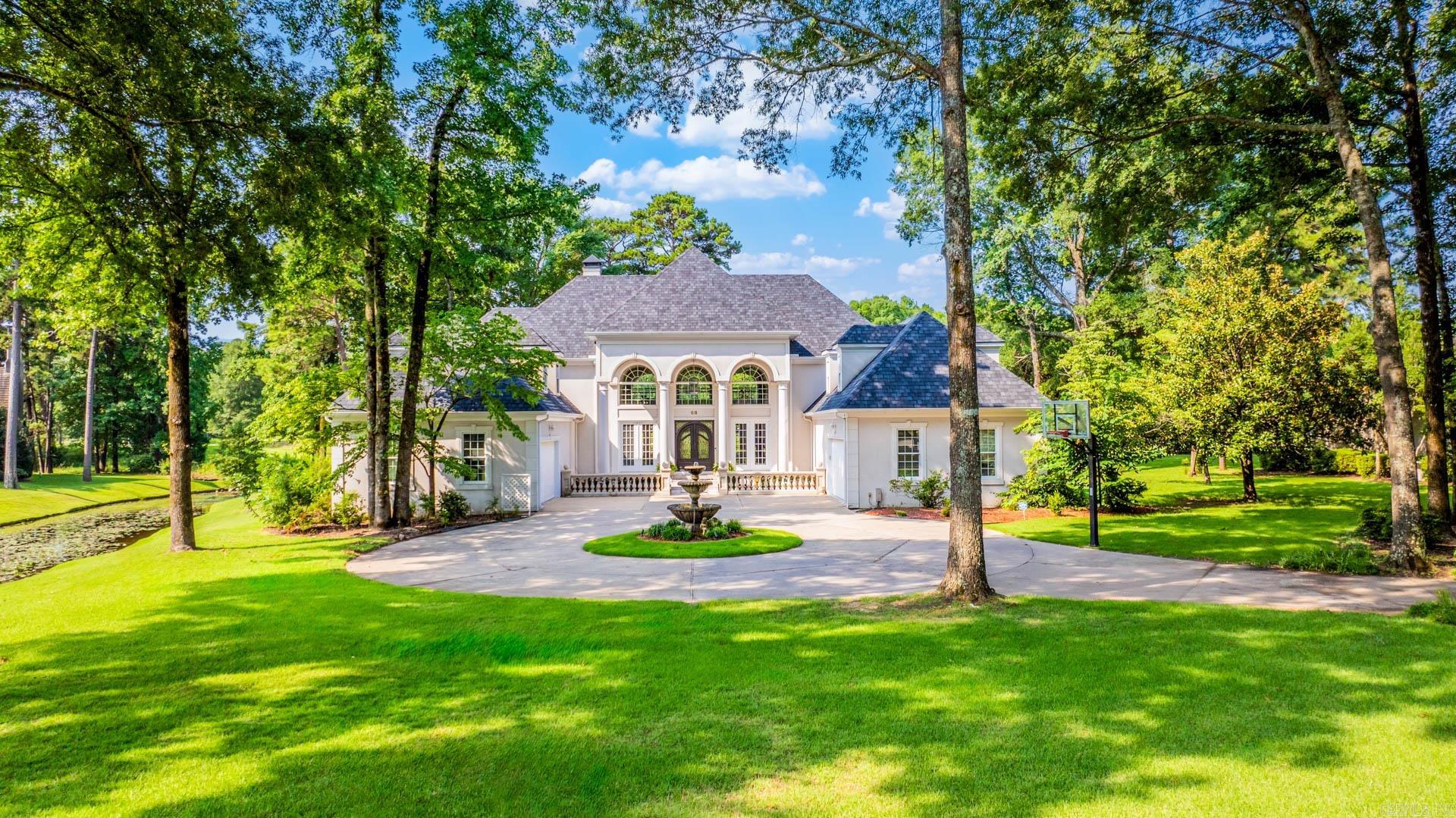 Architecturally designed home backing to Founders Golf Course is sited on 1.17 acres in The Chenal County club. The main floor features a foyer, living room, dinning area, den, kitchen, office, master suite, guest suite, and stunning sunroom. Kitchen totally remodeled with custom cabinets, and granite counters. Upstairs has four bedrooms with three full bath, game room, and additional French veranda. Every room is oversized/perfect, and every window looking out onto the water and golf course. Additional features include extra kitchen, 4 car garage, fountain, and circular driveway. Precious builder ( Randy Ferguson)ās home ā French Villa Style Living featured in " Life in Chenal"!