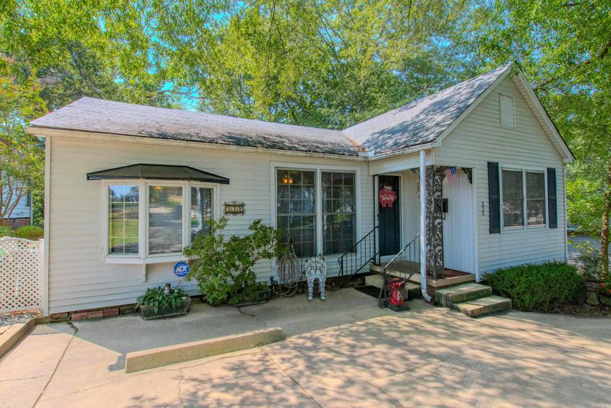 This well-maintained home features original hardwood floors in the main living area, adding timeless character and warmth. The updated kitchen boasts abundant cabinetry, generous counter space, and beautiful quartz countertops—perfect for cooking and entertaining. Enjoy the versatile sunroom and a dedicated office space with built-in shelving. Step outside to a spacious deck overlooking a flat, fenced backyard with mature shade trees—ideal for relaxing or entertaining. Additional features include outdoor storage and a convenient circle driveway. A must-see property in a sought-after location! See agent remarks.