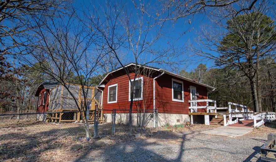 Rustic home on 5 acres with 40x60 shop, 8x10 outbuilding, 10x14 outbuilding, 2 carports, Generac generator, 2 screened in porches. This great home has so much to offer with large bedrooms, dining room for large family gatherings, build-ins, handicap design inside and out, and much more. Would make a great air bnb or family home. Located in Mena, AR. Agents, see remarks