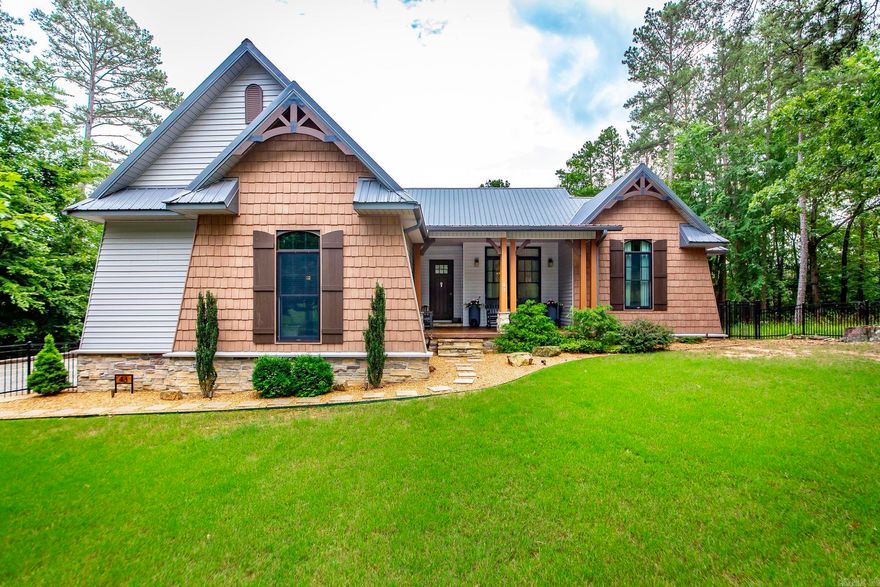 RIVERFRONT custom built home right on the river! This beauty is nestled in the woods with landscape lighting to set the relaxing mood and paved road to the dock.  Custom fencing just installed and even a kennel under the deck for furry friends! Soak up the amazing open floor plan with huge kitchen accented with custom cabinetry, big breakfast bar with leathered granite and even a refrigerator with a built in keurig! Woohoo! High end GE Cafe appliances with convection oven.  Primary suite will blow you away with all the room!  Jack & Jill plan for kids and bonus room upstairs for game room or guests. So many improvements to make this your dream come true home!  Whole home generator and metal roof, too! CUSTOM draperies and rods can stay with acceptable offer. All TVs will stay. Make your plans to fish or boat off your own dock with covered slip. Life is good on the river!  See docs online for improvements, features, SPD etc.