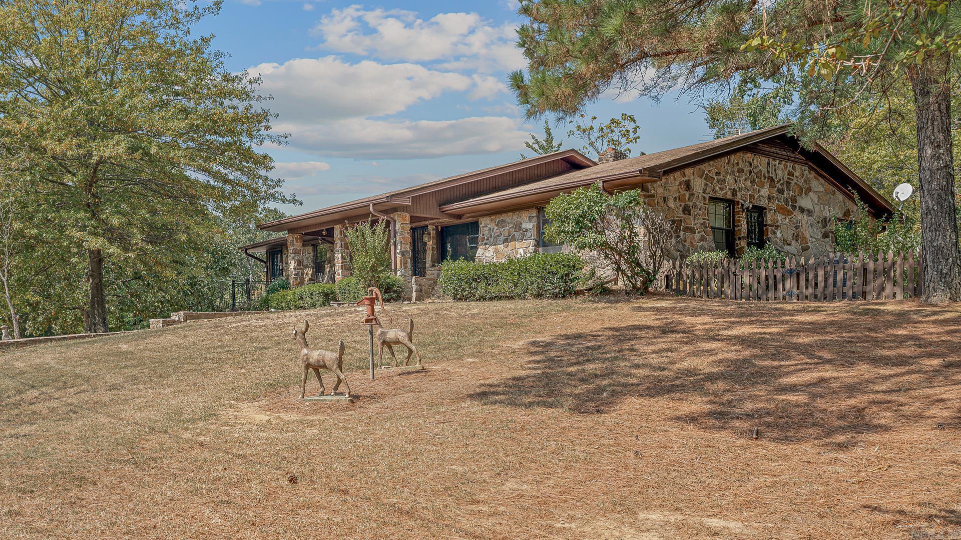 This exceptional property offers an incredible opportunity to own not one, but two homes on 5 acres in the heart of Crowley's Ridge, just outside Harrisburg, AR! Enjoy the tranquility of country living with wildlife, while still being close to town. This unique property has a inground swimming pool, a tranquil gazebo, and a detached shop (40 X 60), making it a truly special find.This property includes two separate homes, providing ample space for family, guests, or even rental income potential.
