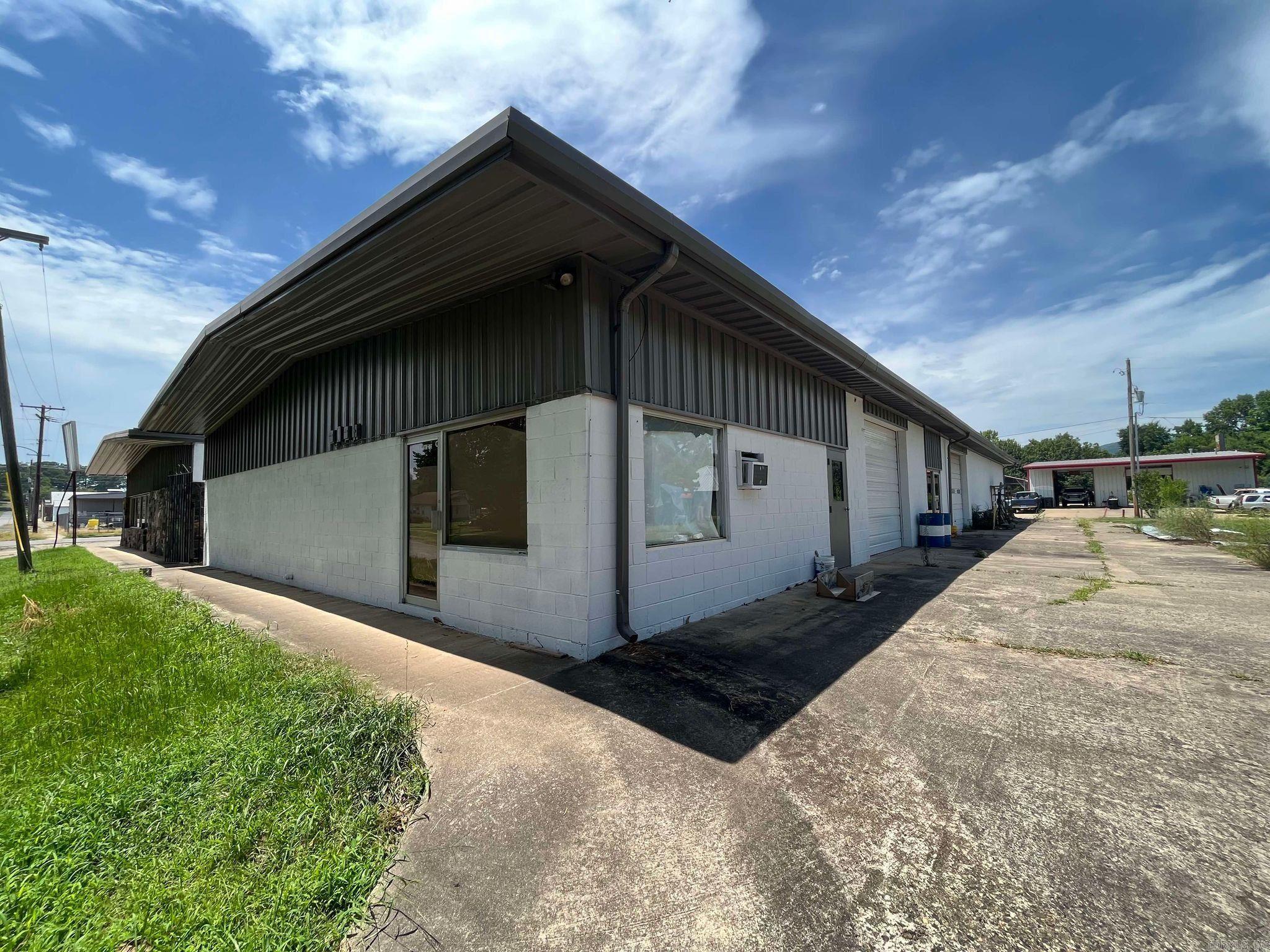 Large and spacious Commercial Building with 3 separate garage style spaces in the heart of Mena. Currently houses multiple businesses, making this a fantastic investment opportunity! Red iron construction with vaulted ceilings, concrete floors and garage doors. Plenty of customer and staff parking. Comes with a valuable 1/2 acre grass lot next door. Multi-use and very functional, this industrial style building would be a perfect place for a BIKE shop, garage shop, or even a storage facility. So many possibilities with this one! INVESTORS TAKE NOTICE!